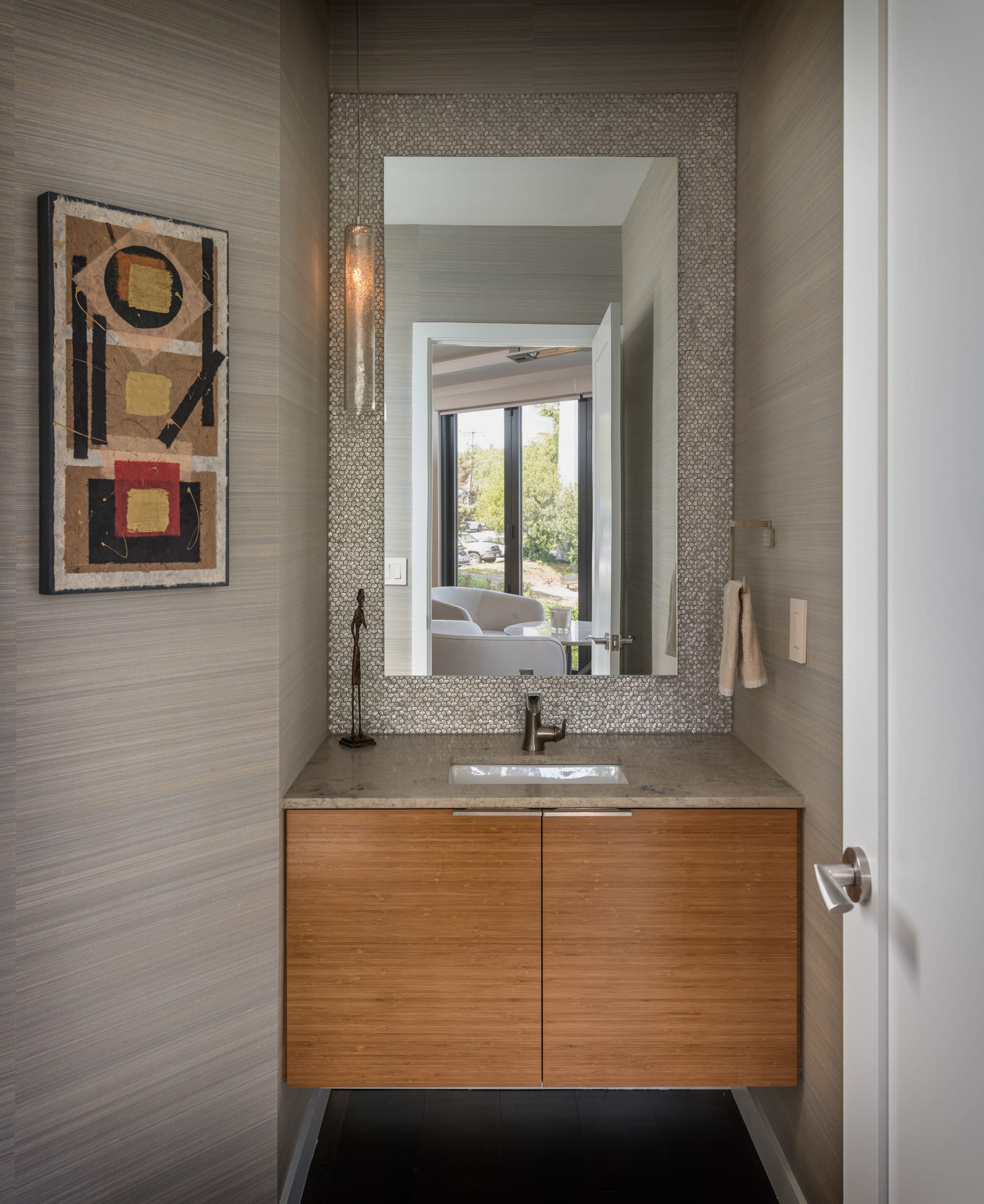A modern bathroom with a wooden vanity and mirror, suitable for a modern home or crafted by a skilled carpenter.