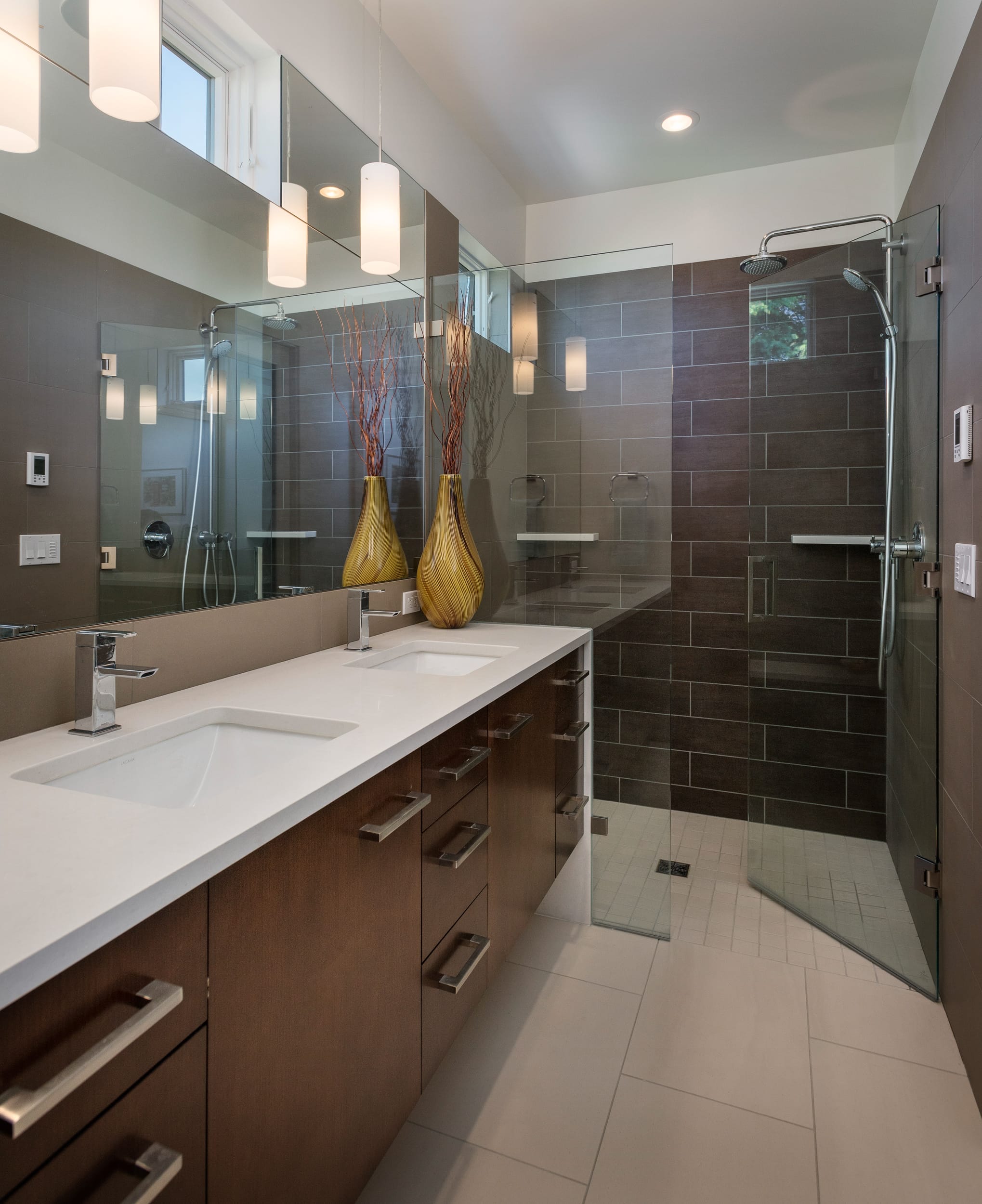 A modern bathroom with a glass shower and sink.