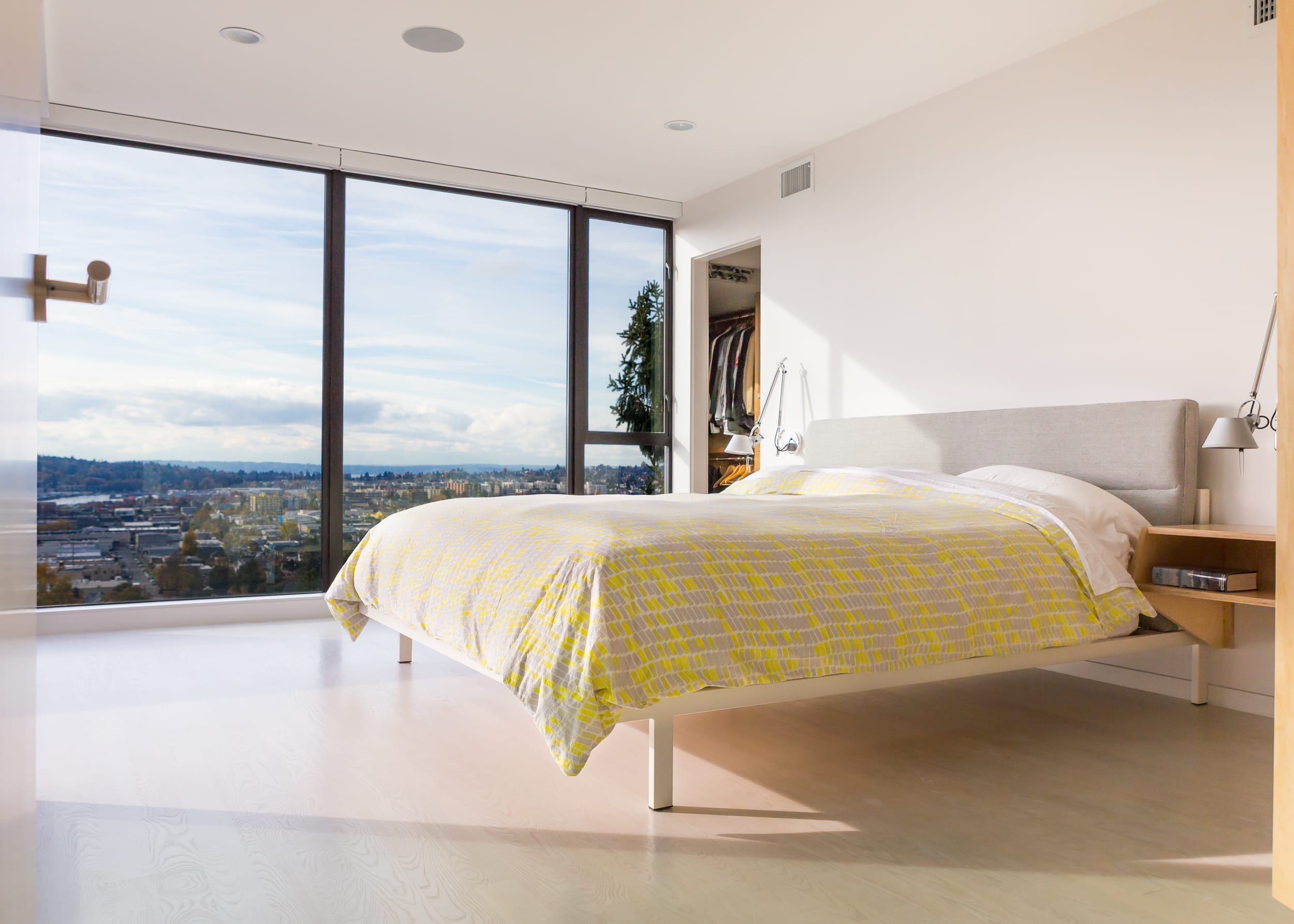 A bed in a bedroom with a view of the city.