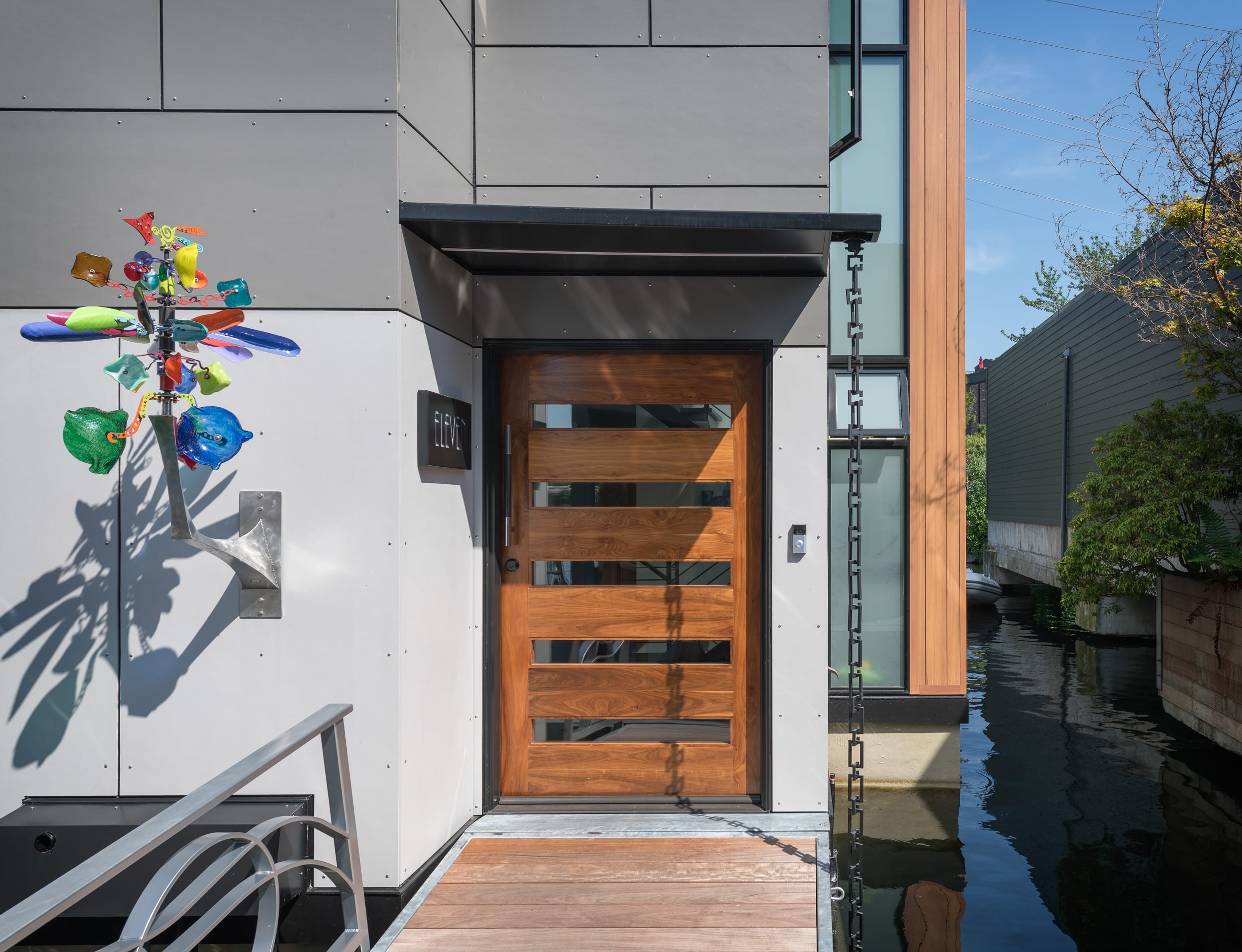 A Modern Home with a wooden door and a wooden sculpture.