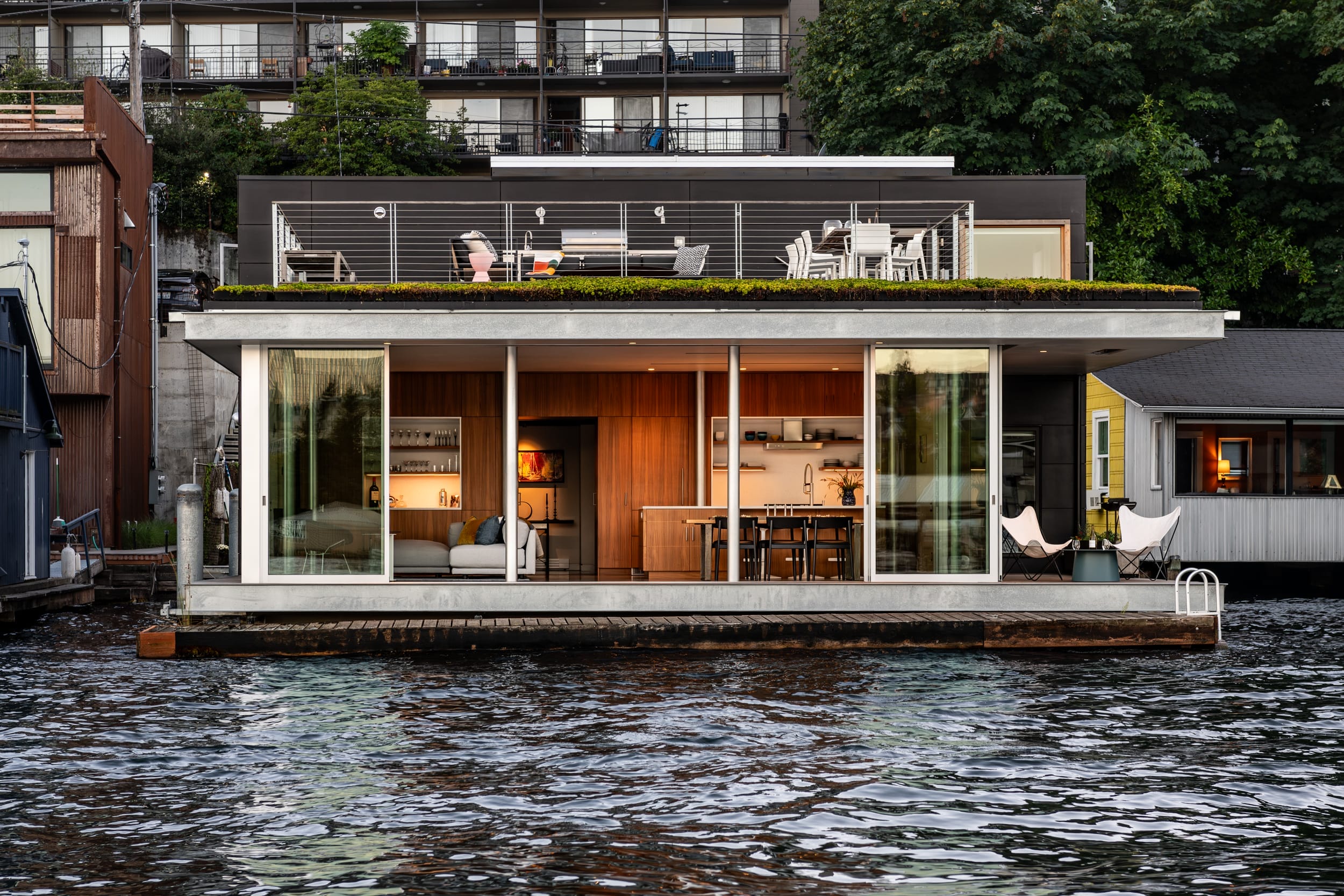 A house on a boat in a body of water.