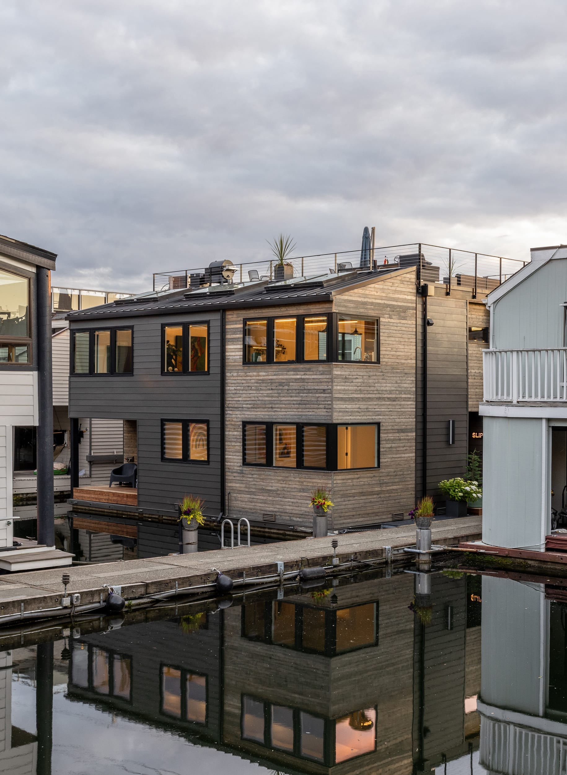 A row of modern houses on a waterway.