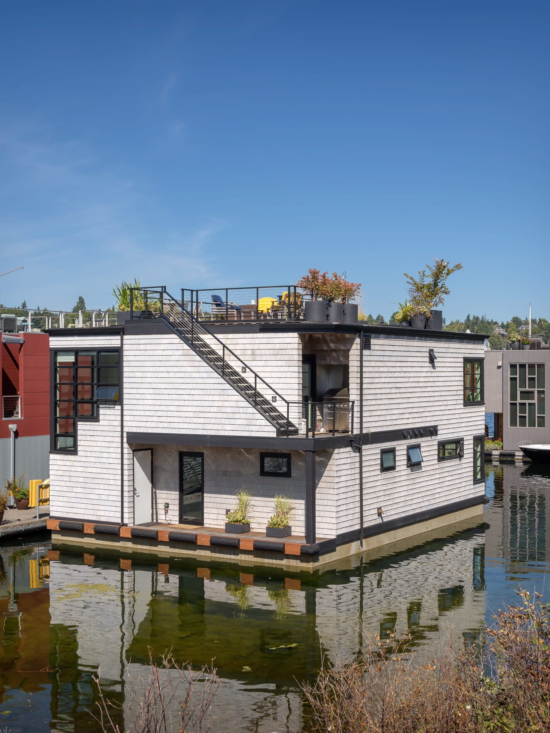 A houseboat is floating in a body of water.