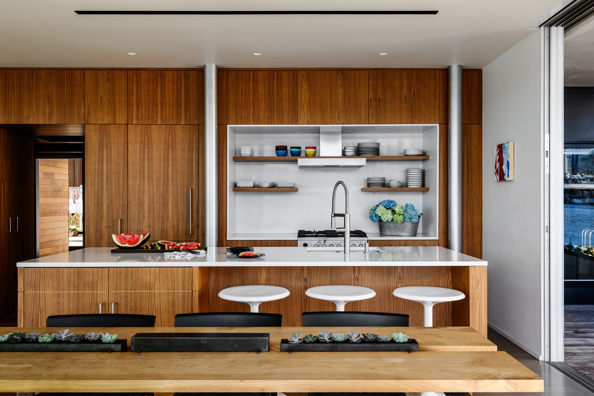 A modern kitchen with a wooden table and chairs.