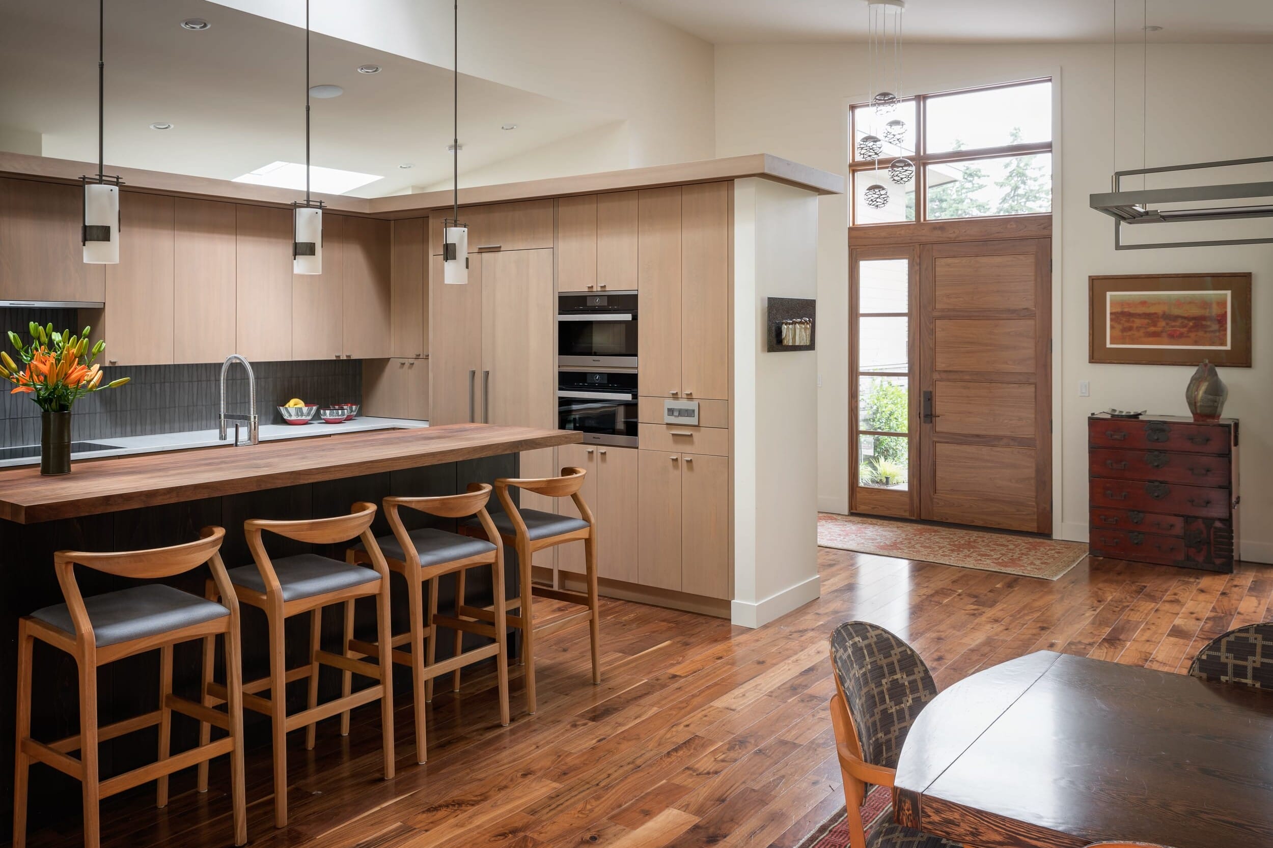 A modern kitchen with wooden floors.
