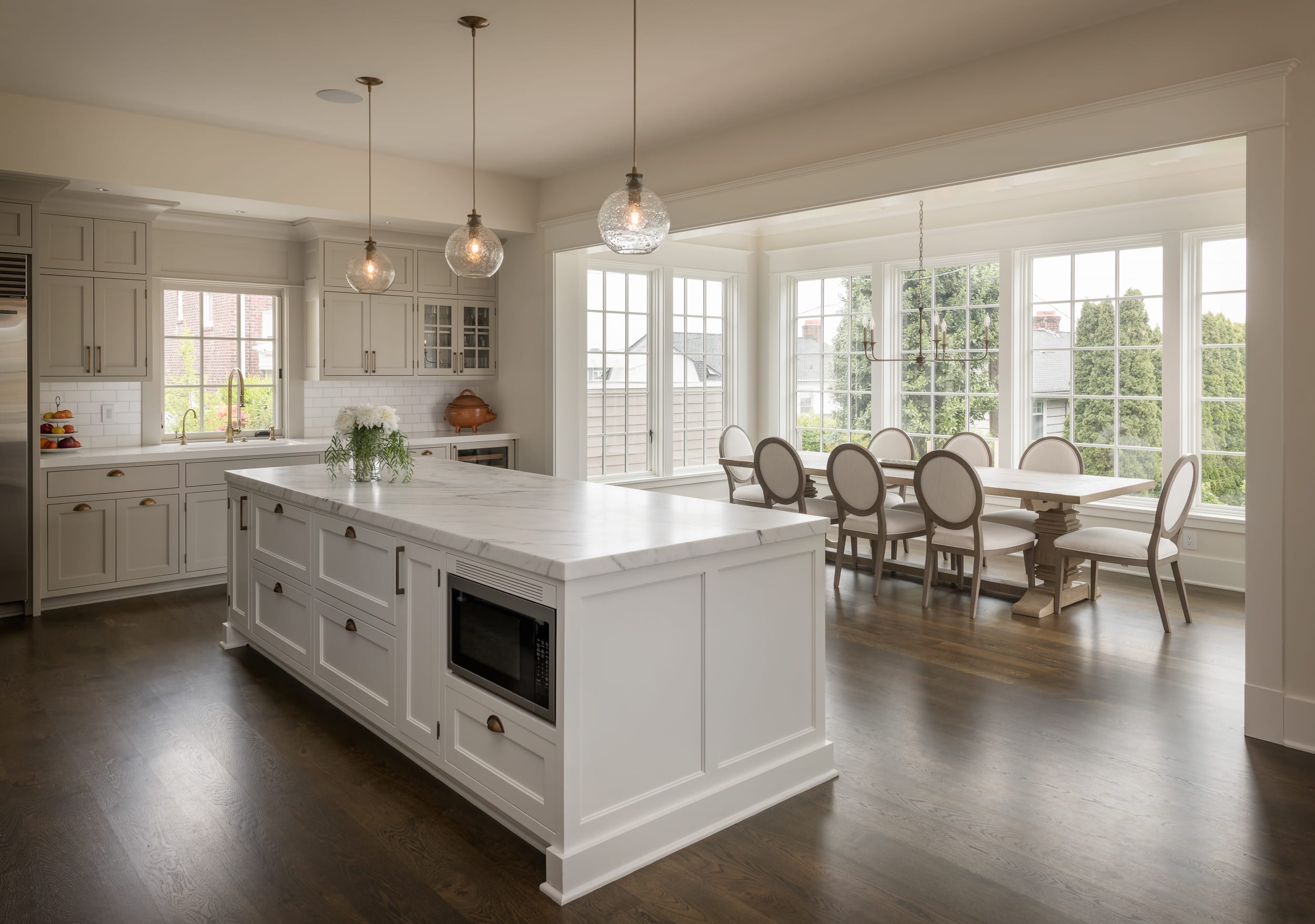 A kitchen with hardwood floors and a large island, built by a skilled carpenter.