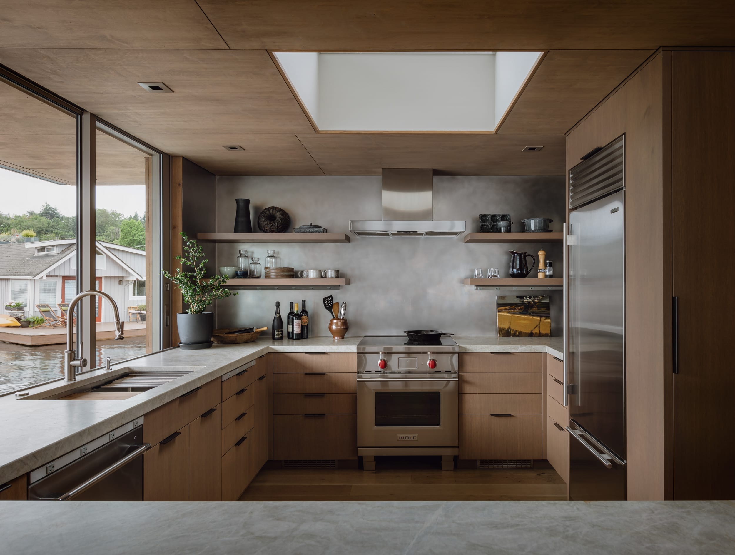 A modern kitchen with wooden cabinets and a skylight in a Modern Home.