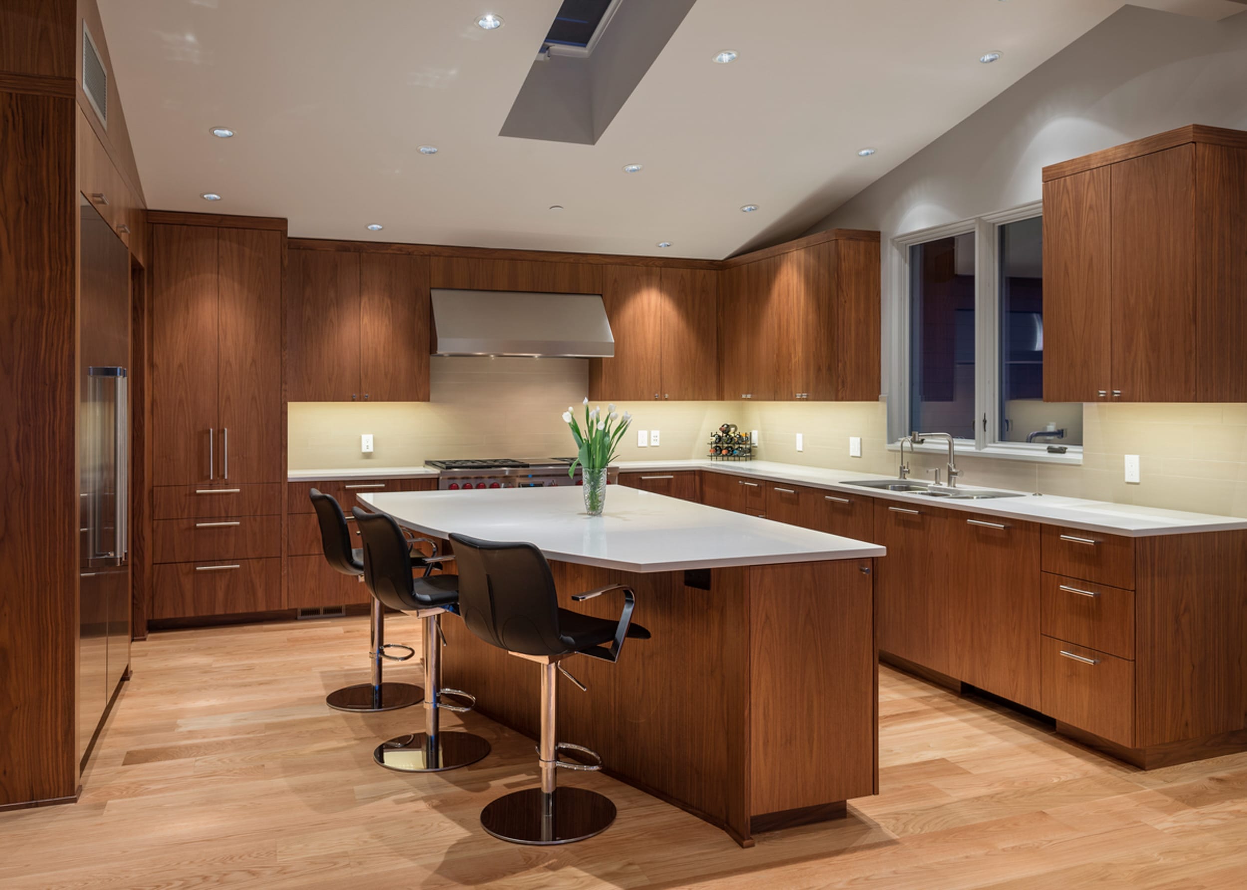 A modern kitchen with wooden cabinets and counter tops.