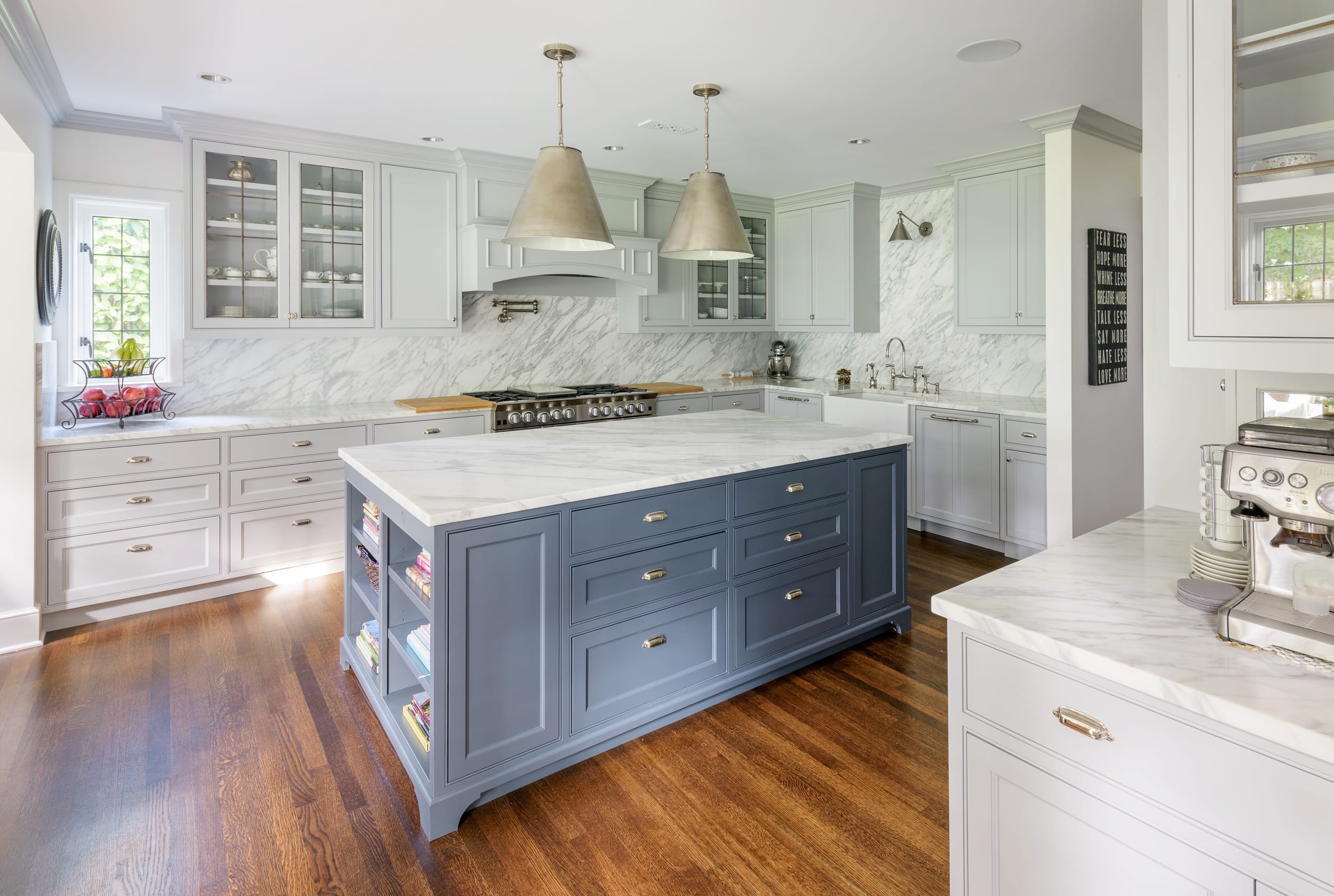 A kitchen with marble counter tops and cabinets.