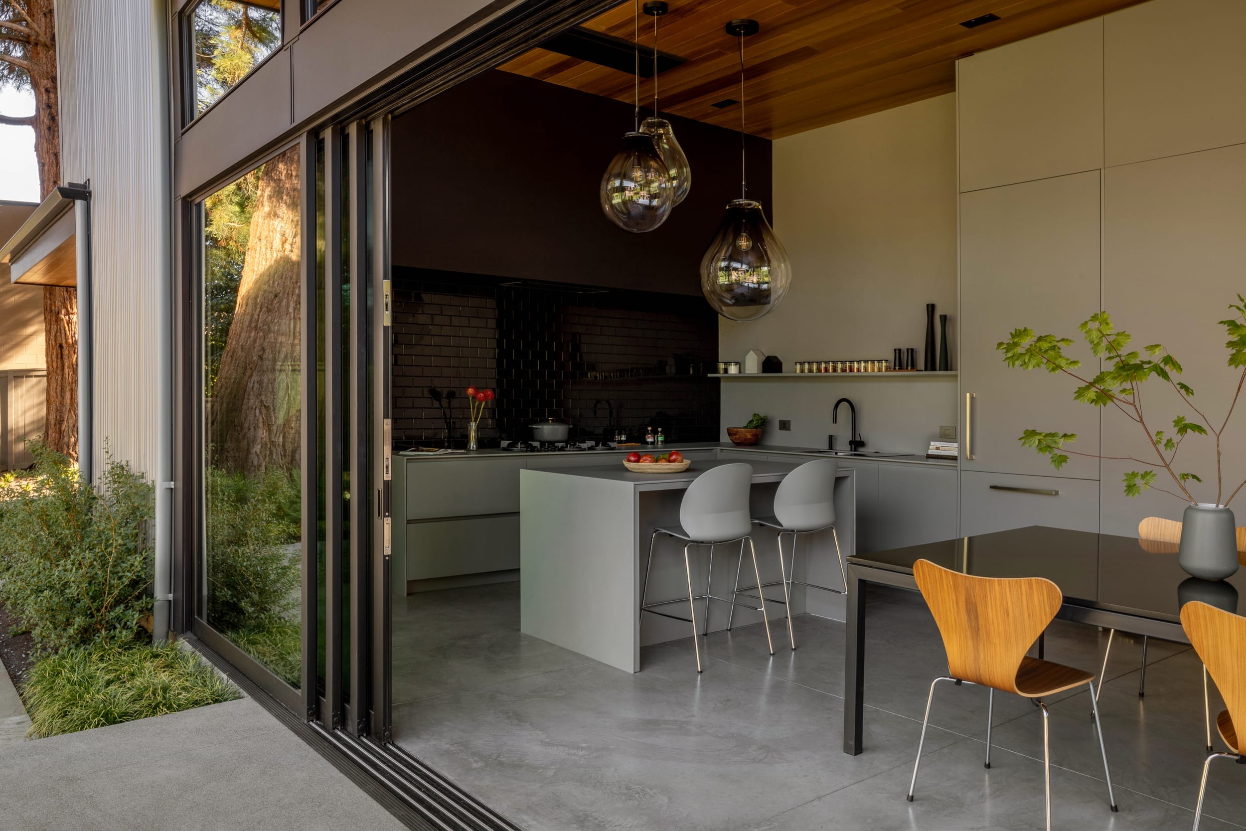 A modern kitchen and dining area with sliding glass doors, perfect for a floating home.
