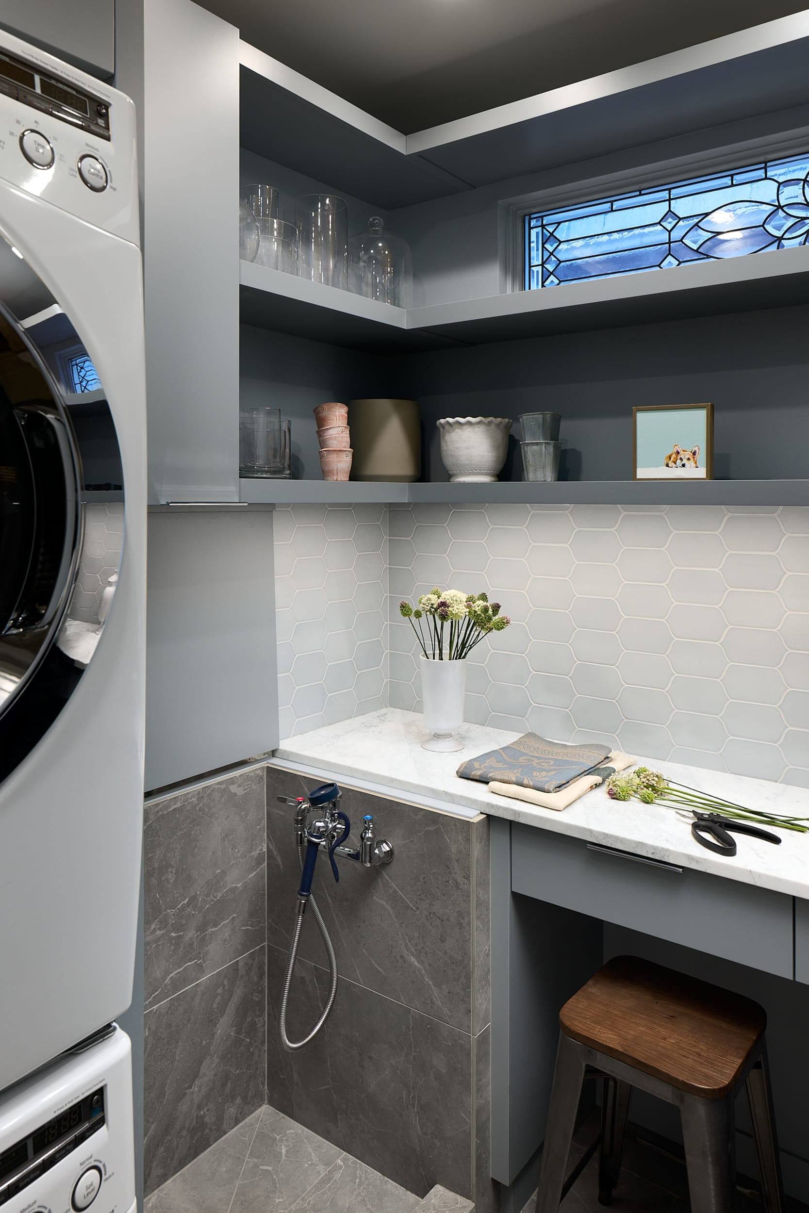 A modern home with a laundry room equipped with a washer and dryer, expertly designed by a skilled carpenter during the home building process.