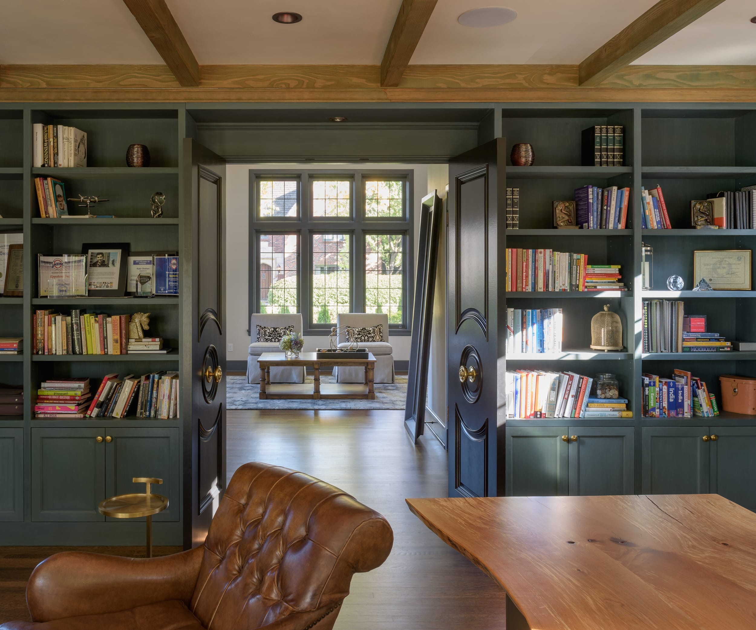 A home office with bookshelves and a leather chair.