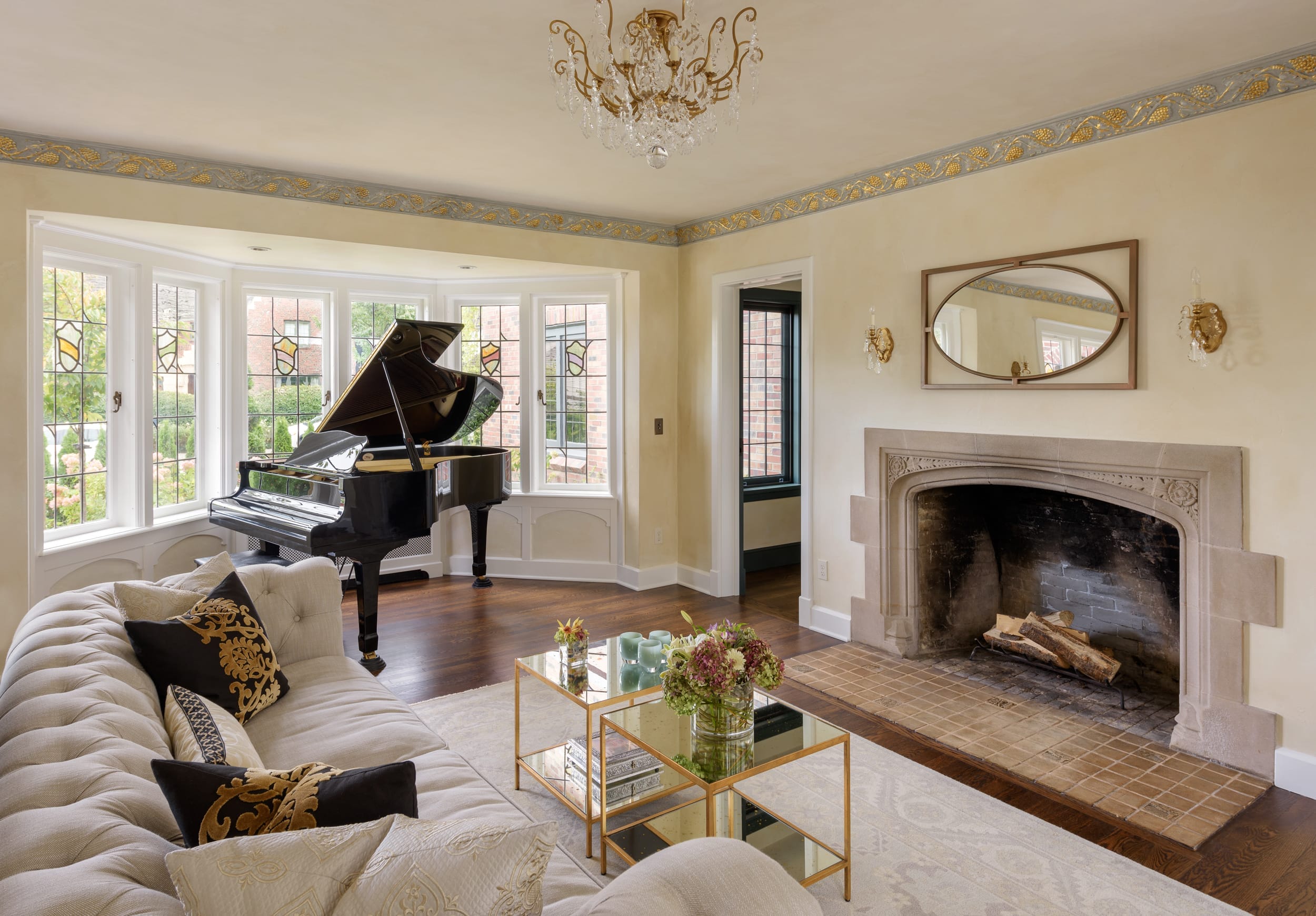A living room with a piano and fireplace.