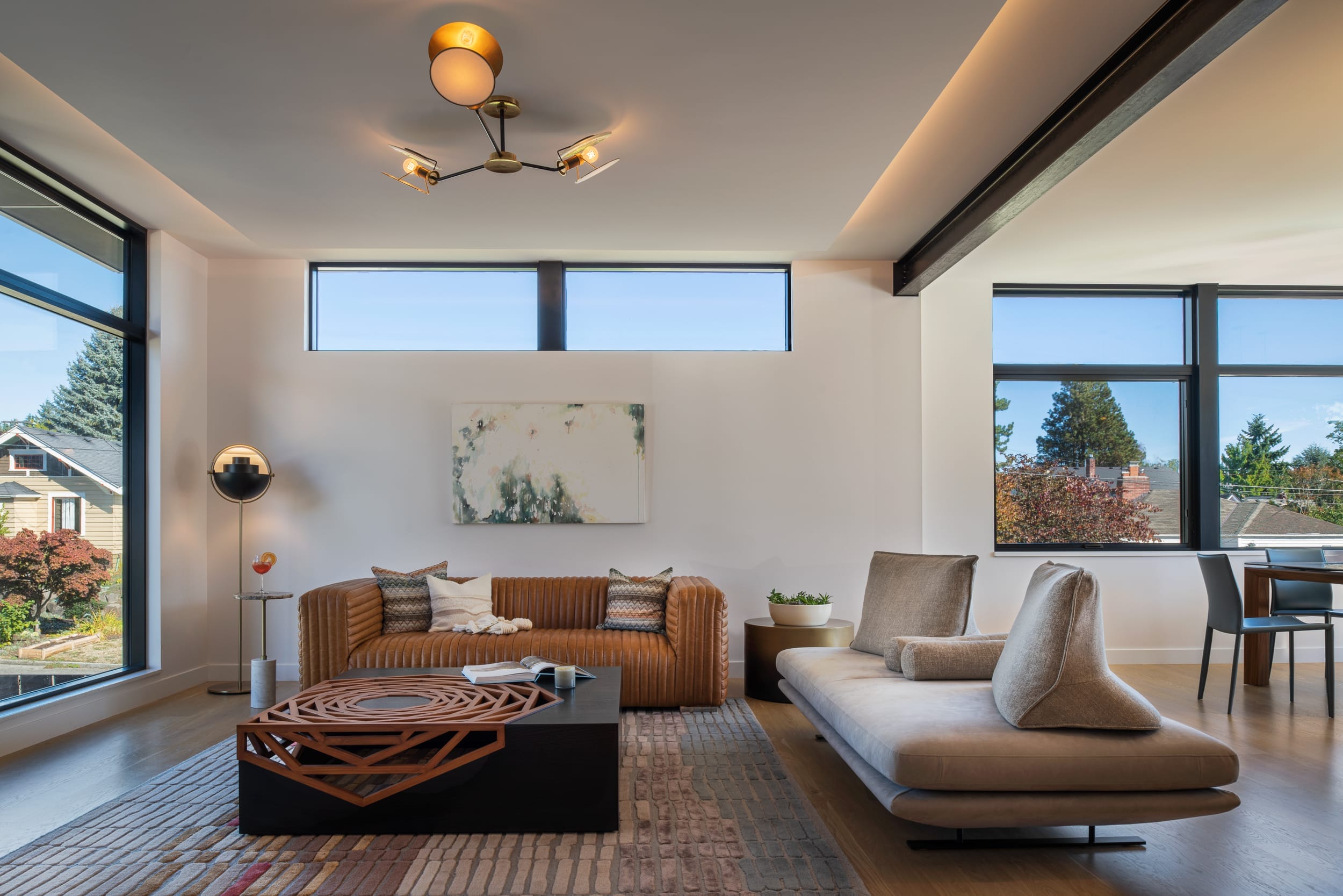 A modern living room with large windows.