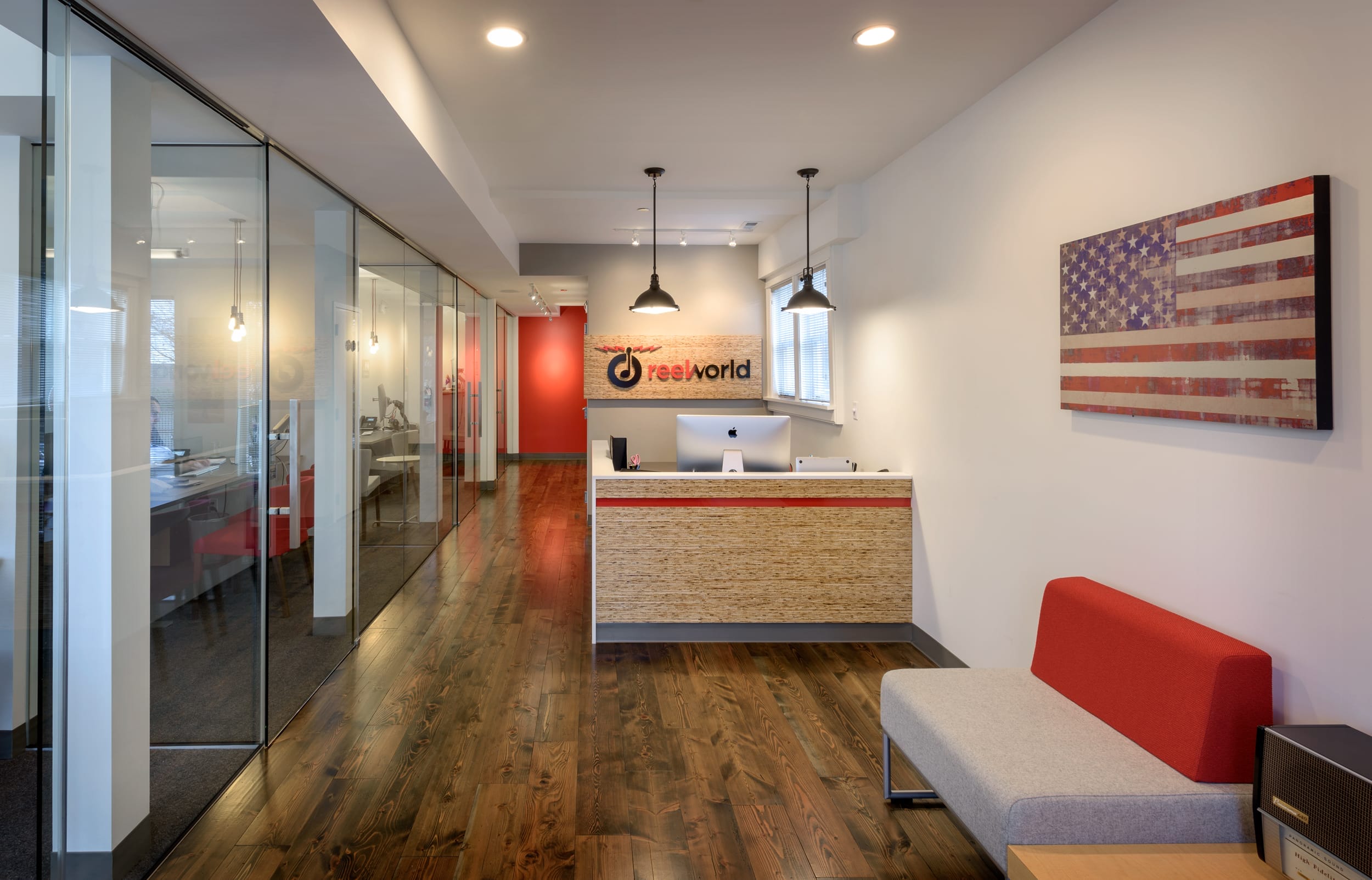 A reception area in a modern office with an American flag on the wall.