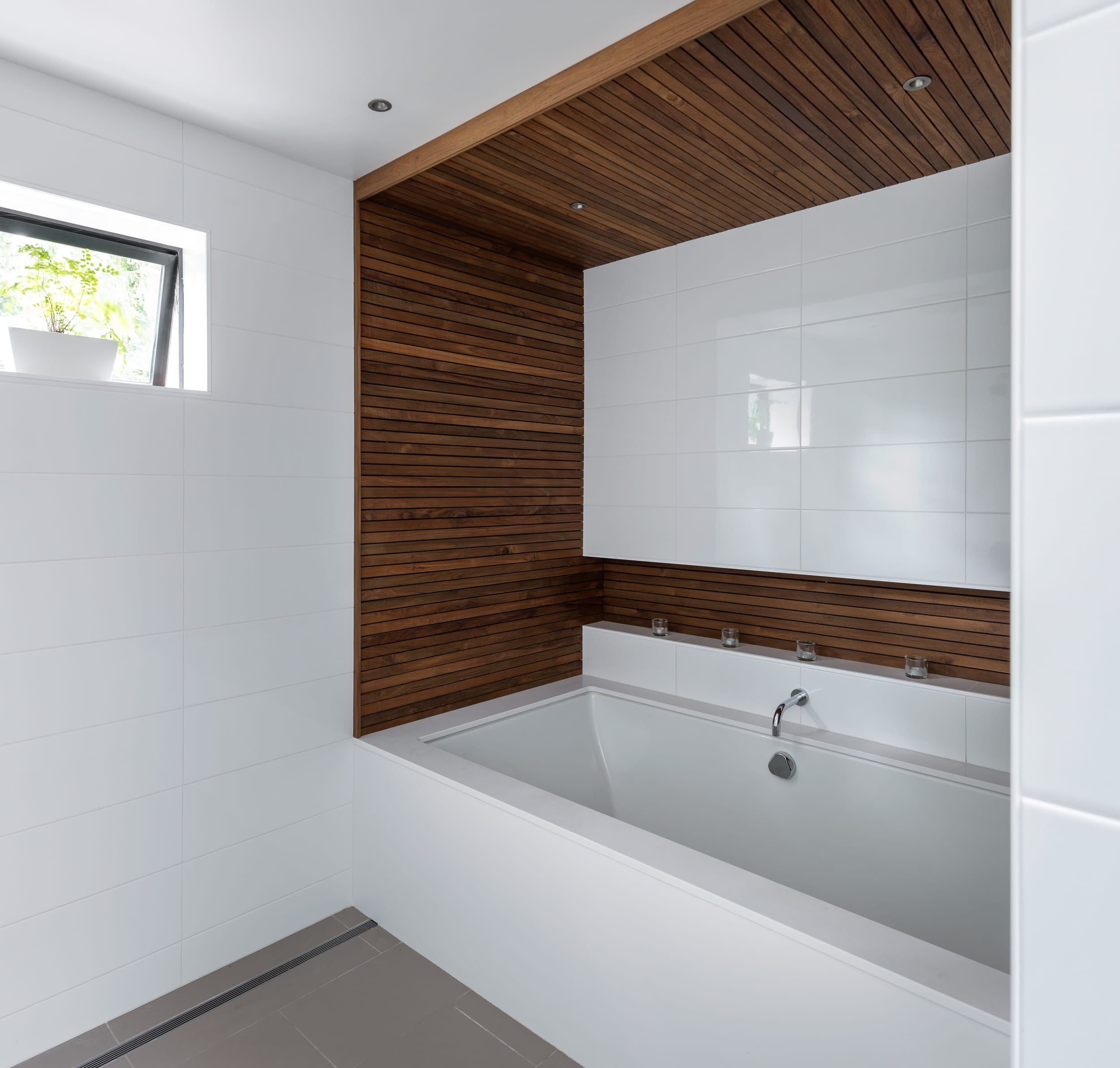 A white bathroom with a wooden ceiling.