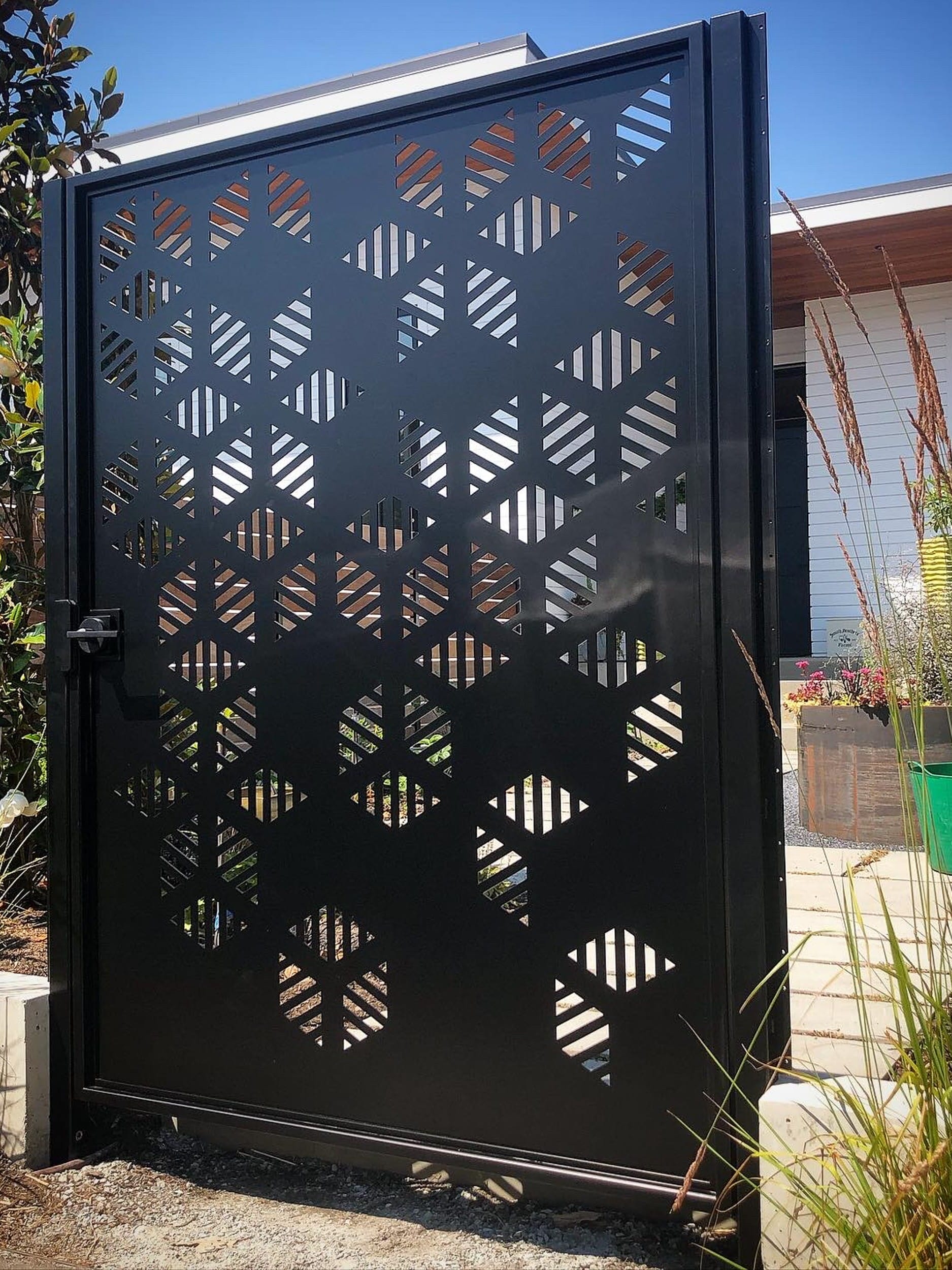 A black gate with a pattern on it.