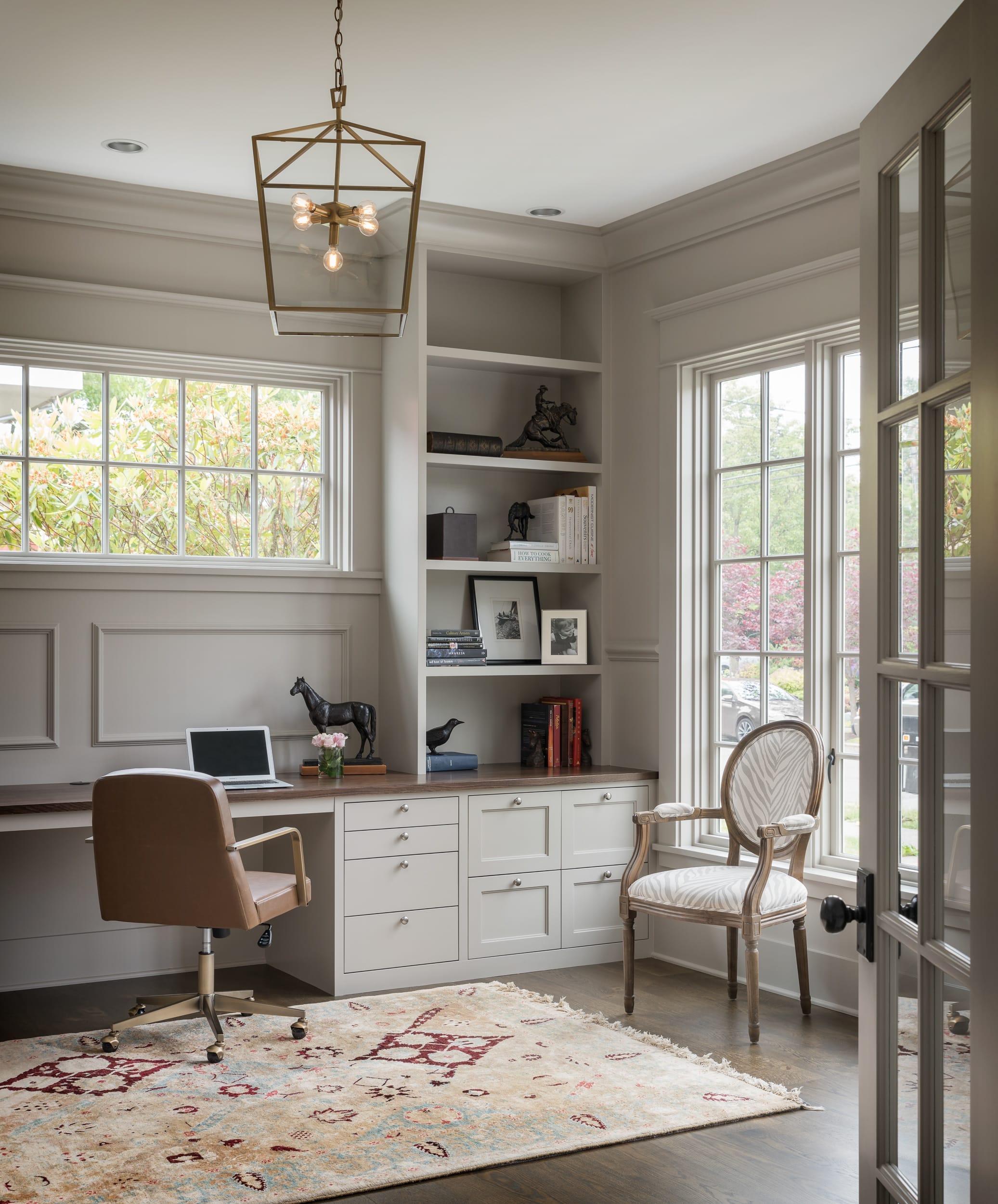 A white home office with floating bookshelves.