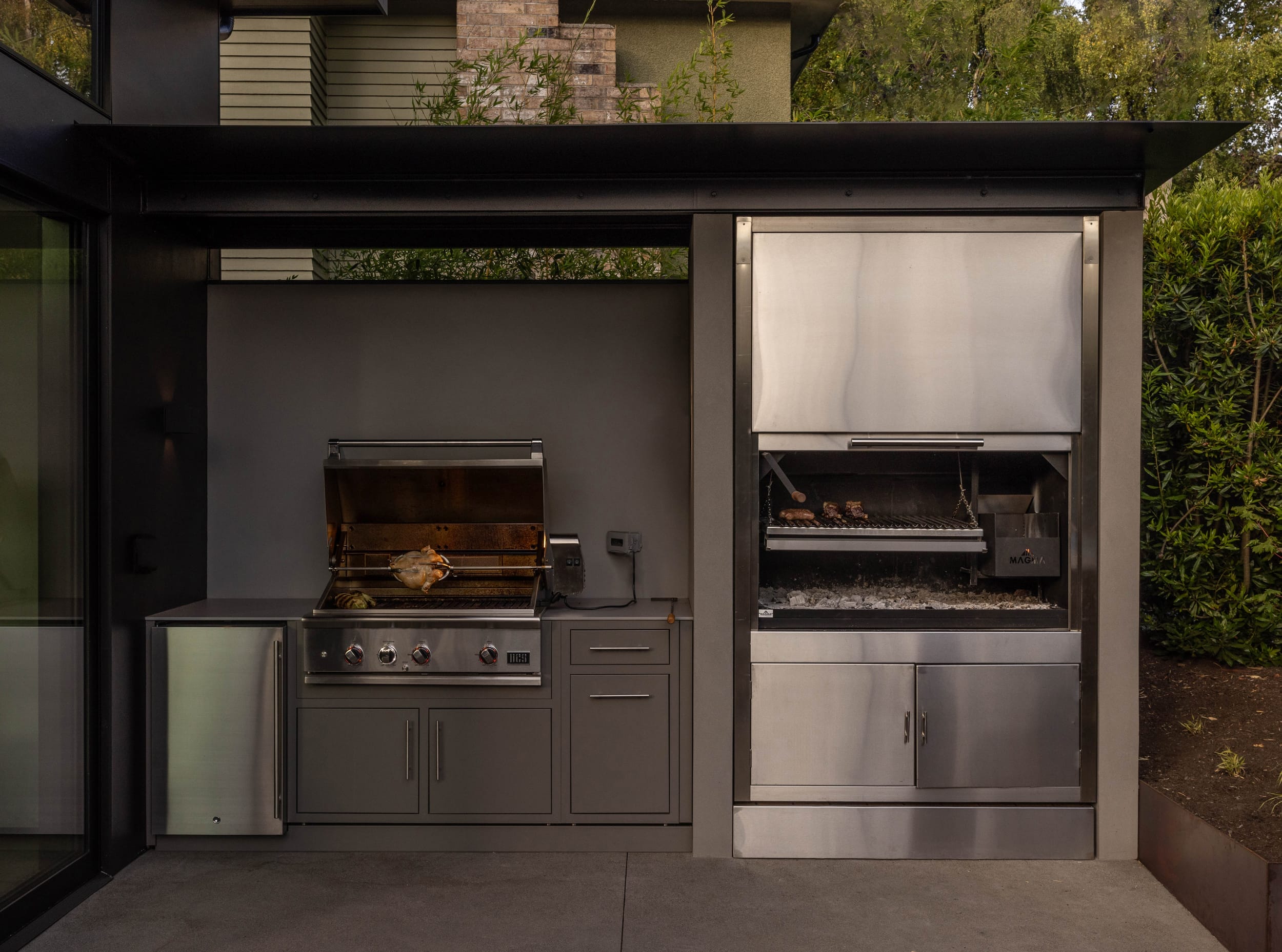 A modern outdoor kitchen with stainless steel appliances.