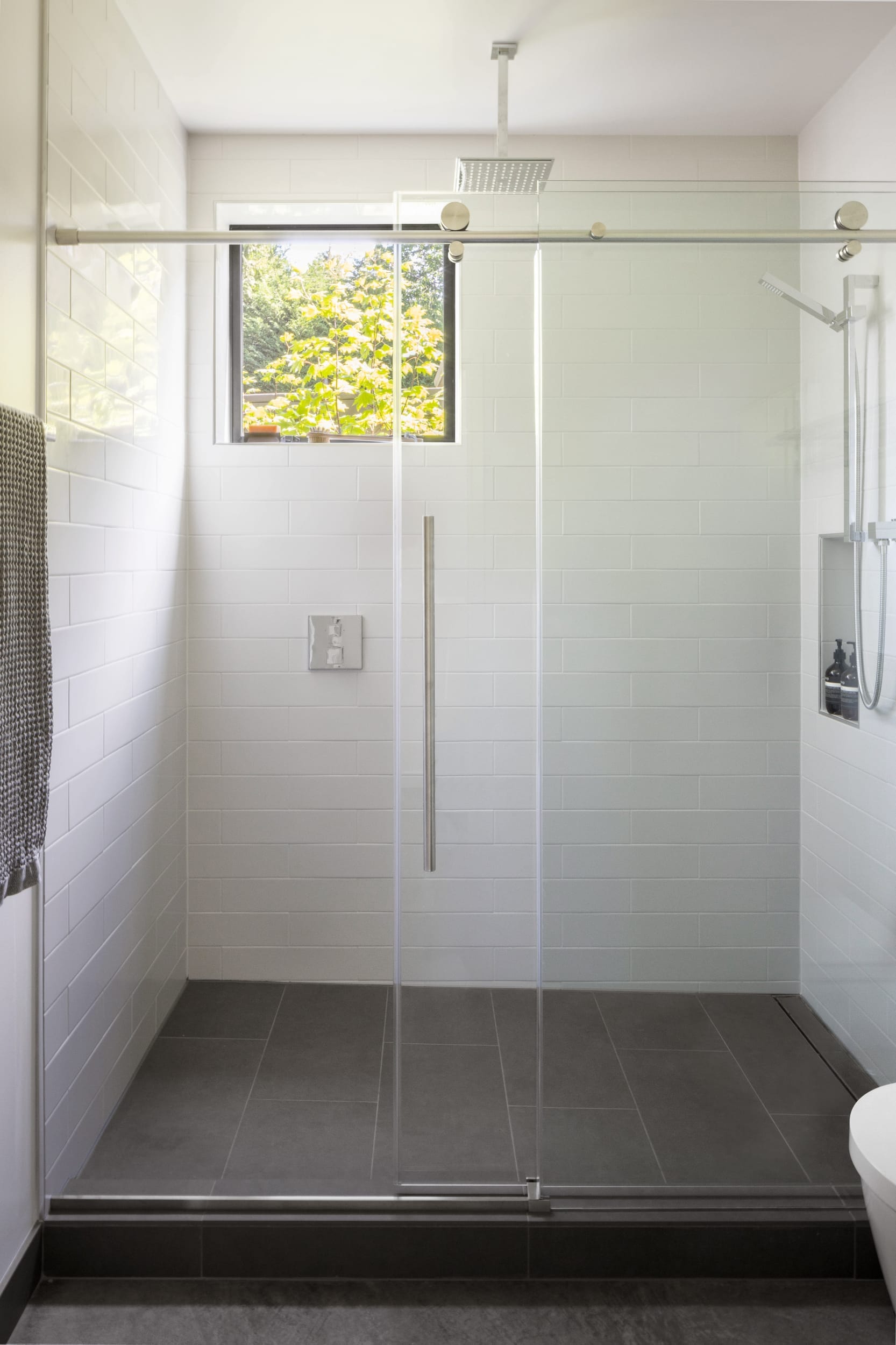 A modern home bathroom with a glass shower door.