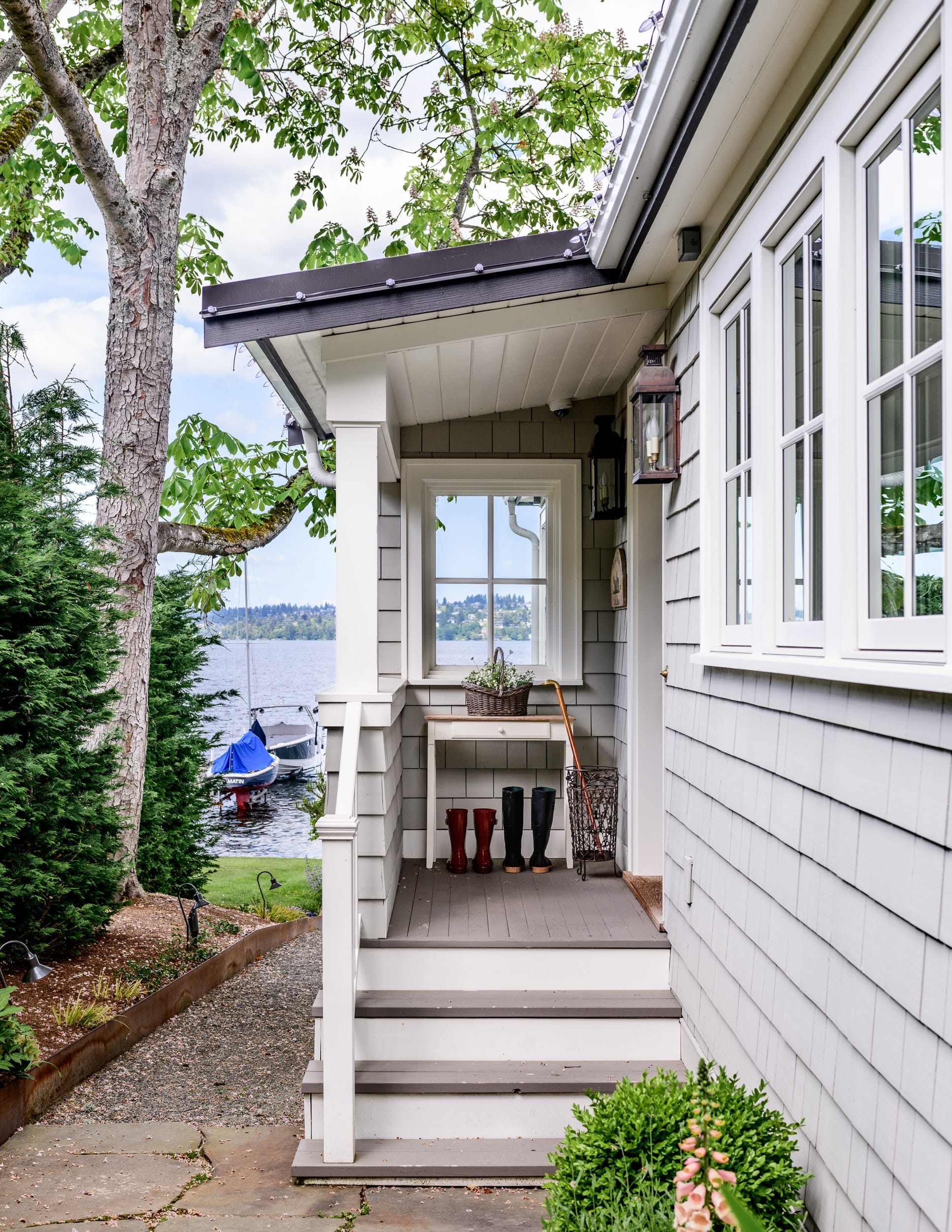 The front porch of a home with a view of the water.