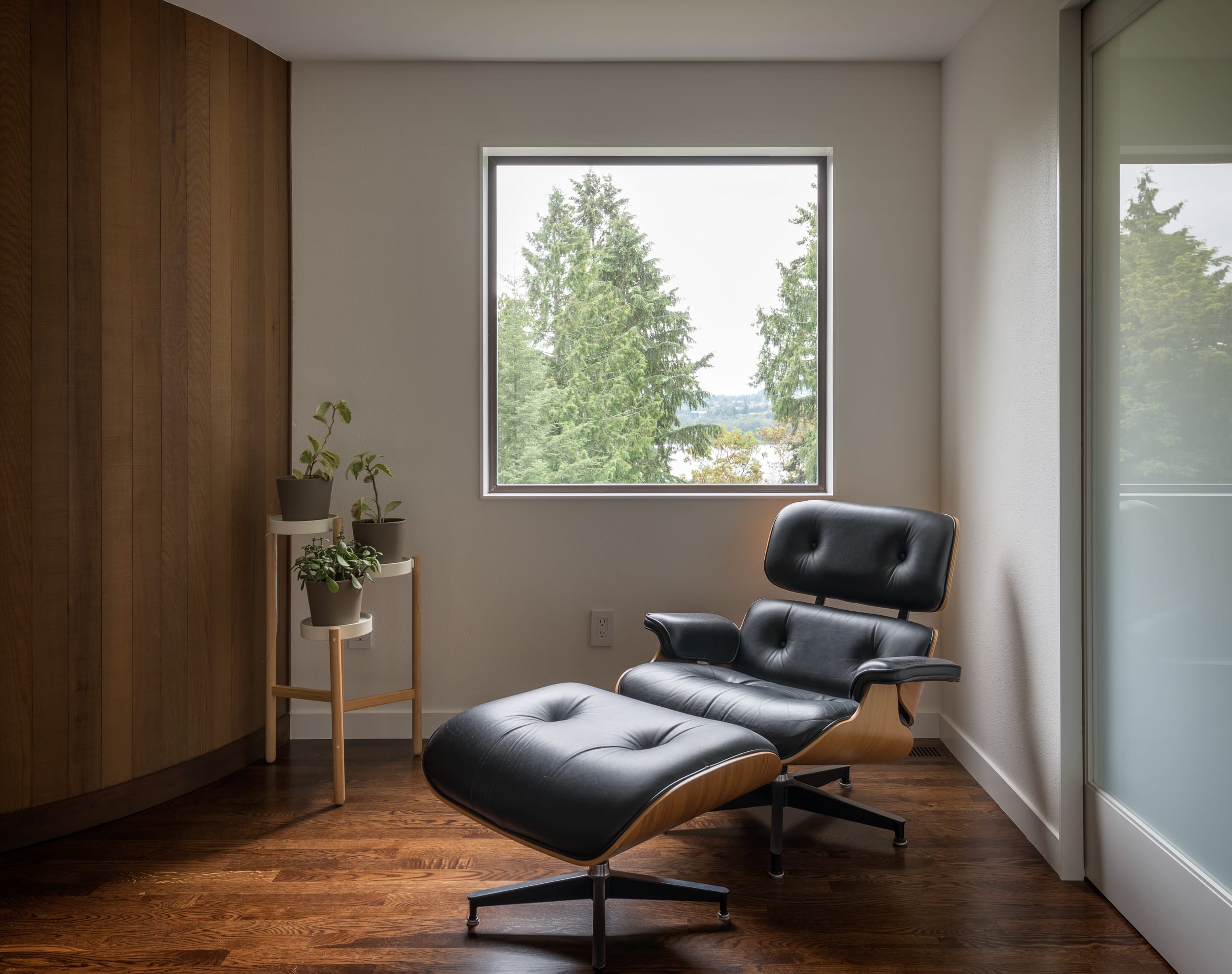 Eames lounge chair in a room with a window.