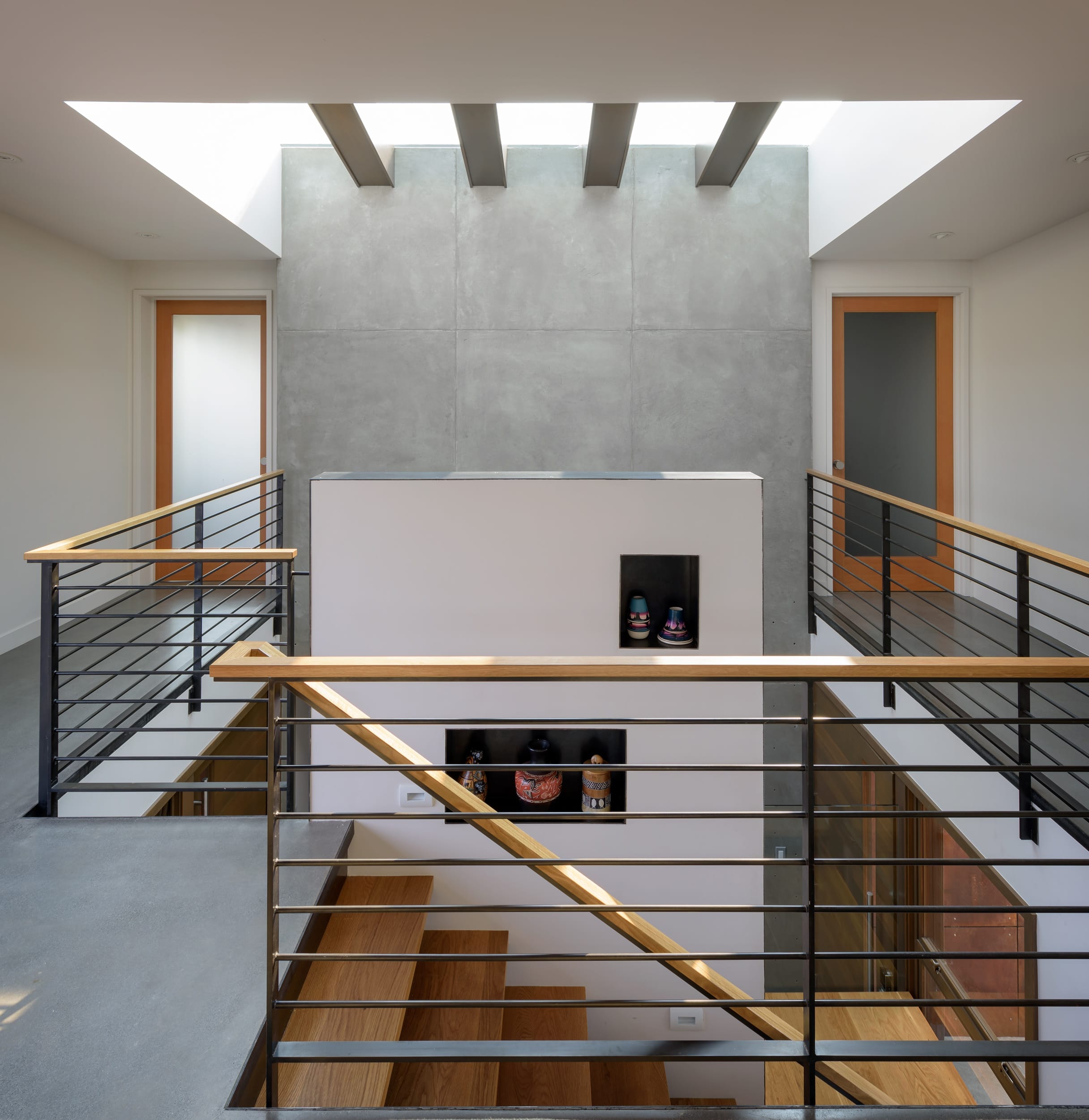 A staircase in a modern house with metal railings.