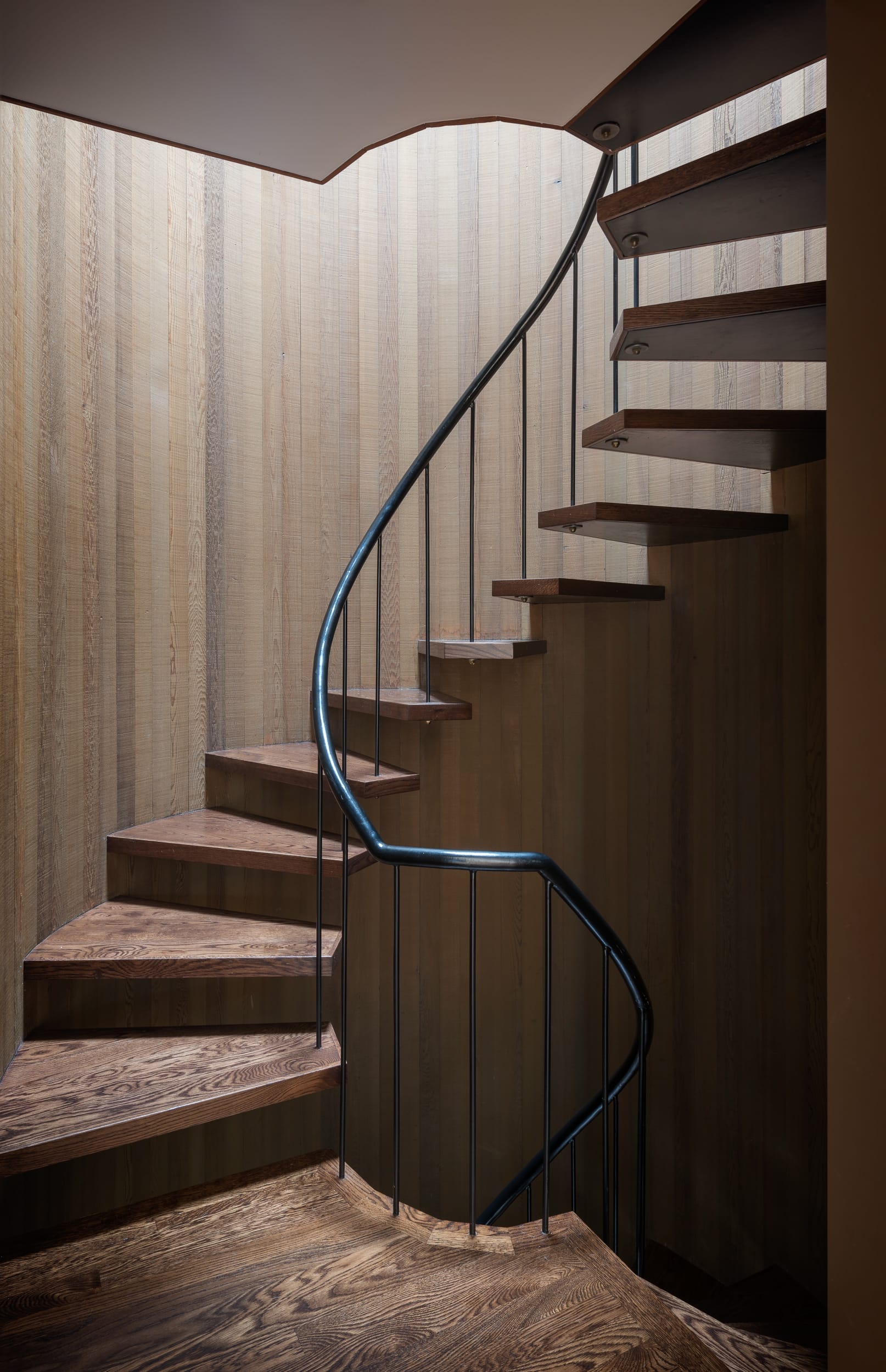 A spiral staircase in a wooden house.