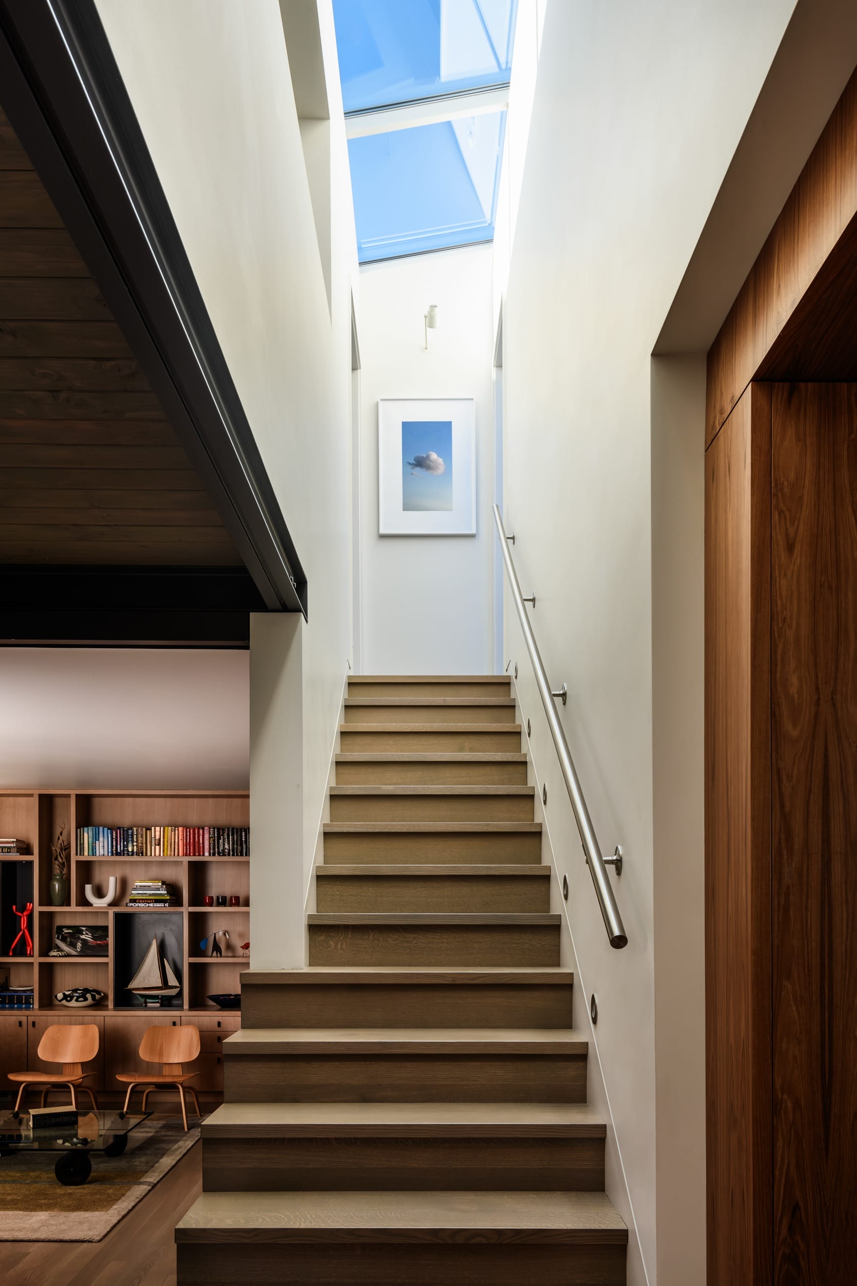 A staircase leading to a room with a skylight.