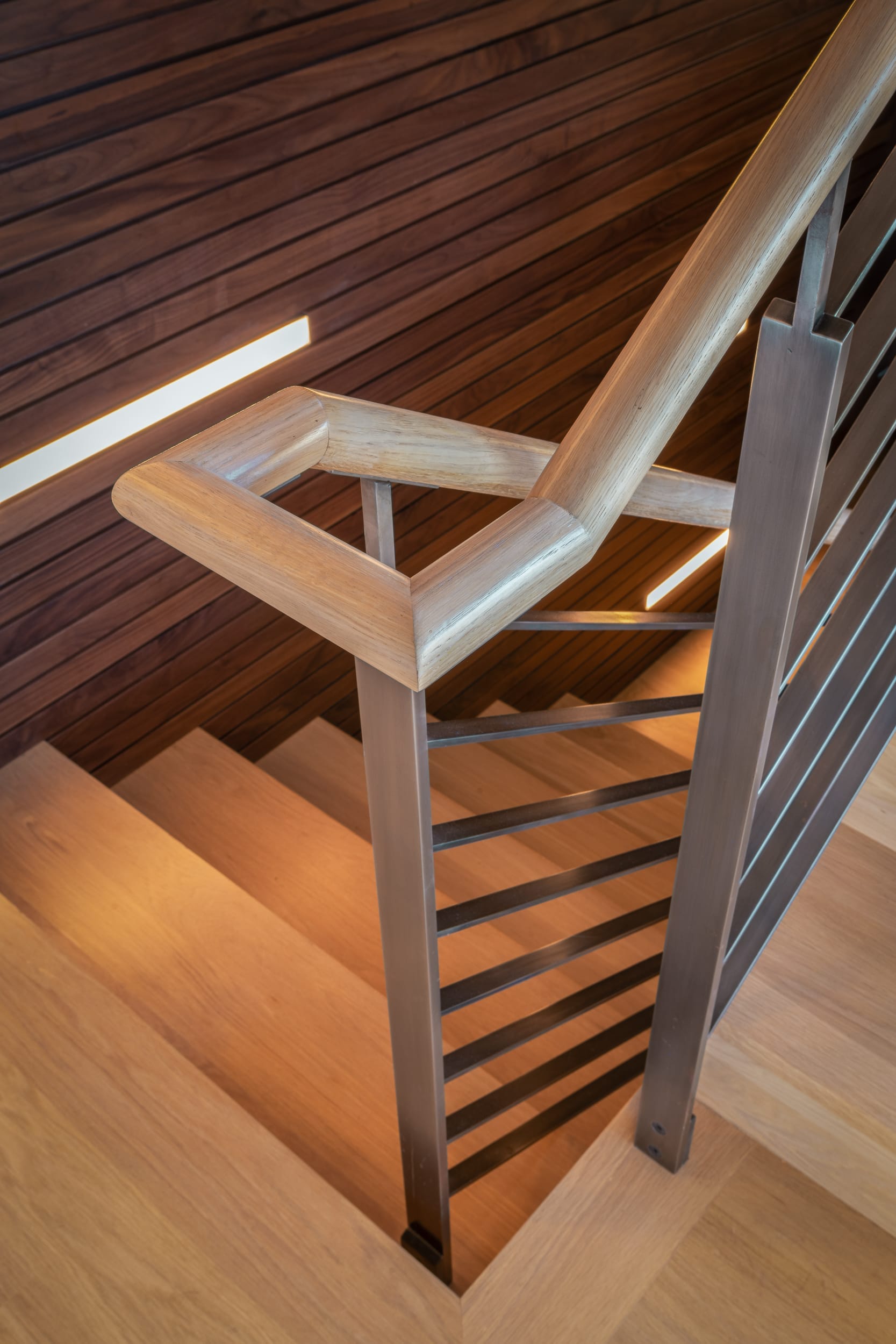 A modern stair railing in a wooden house.