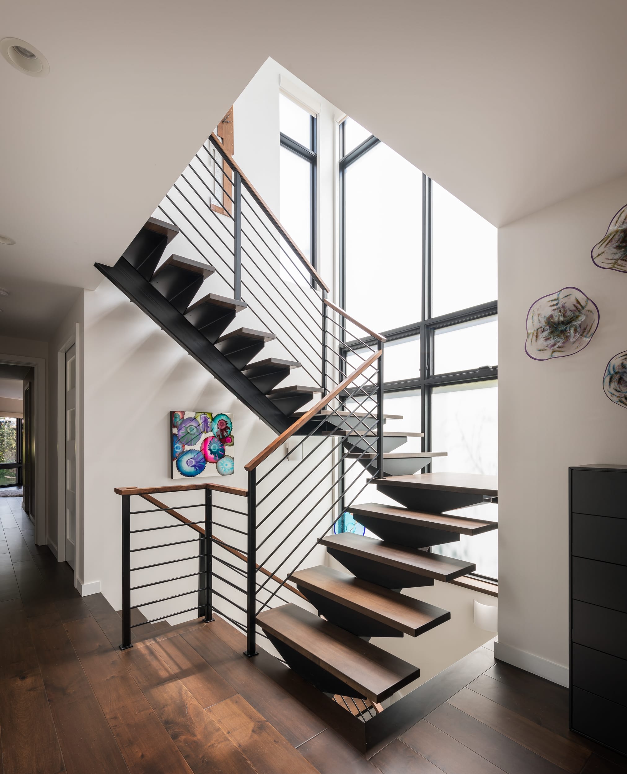 A floating home with a modern staircase designed and built by a skilled carpenter.