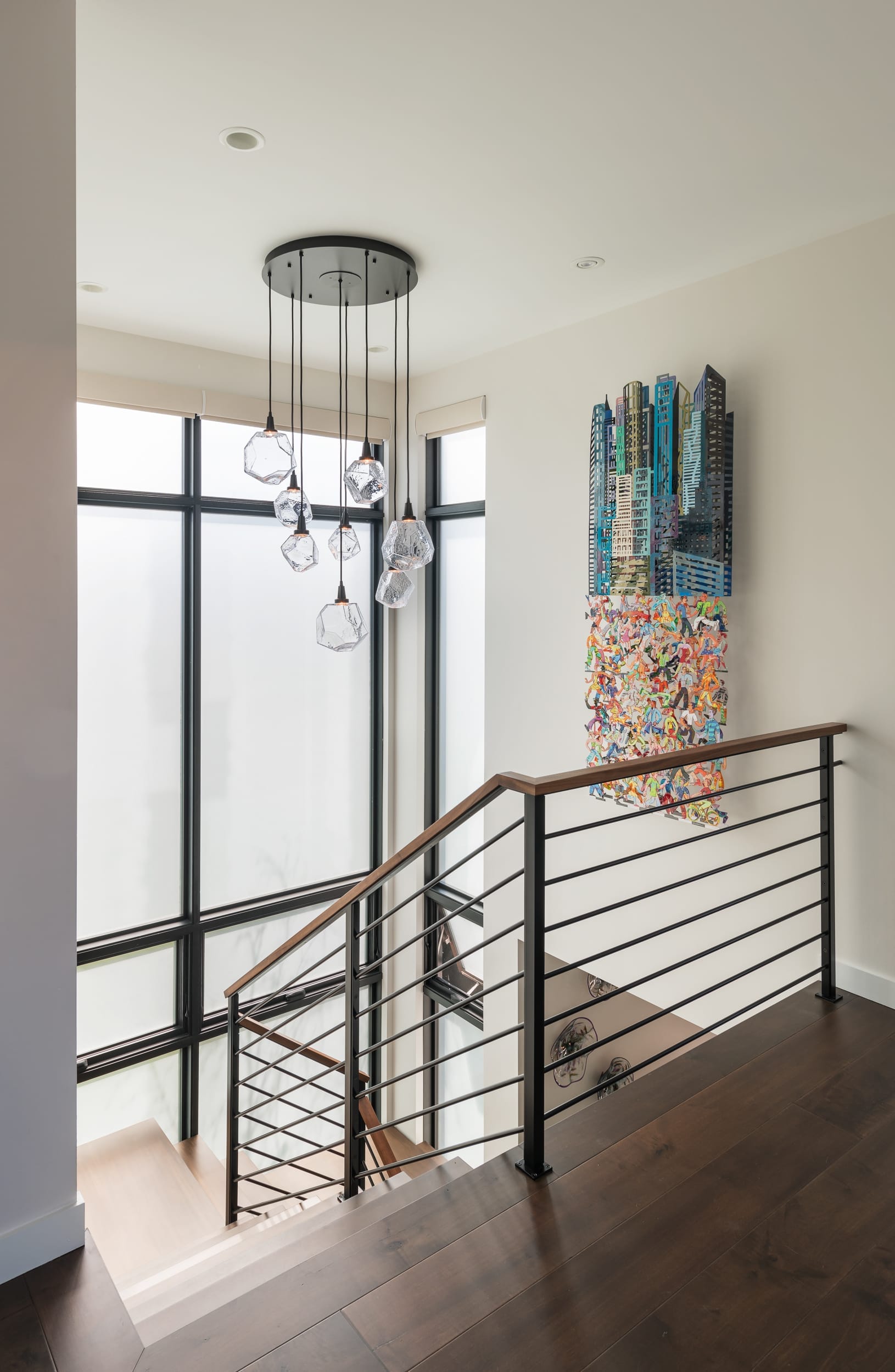 A modern home staircase featuring a painting on the wall, skillfully crafted by a carpenter.