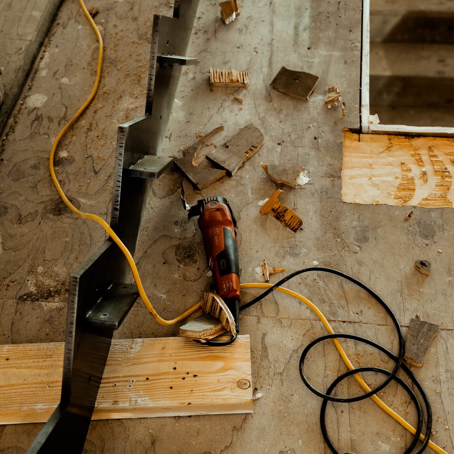 A power drill is being used at Dyna Metal Shop Seattle on a concrete floor.