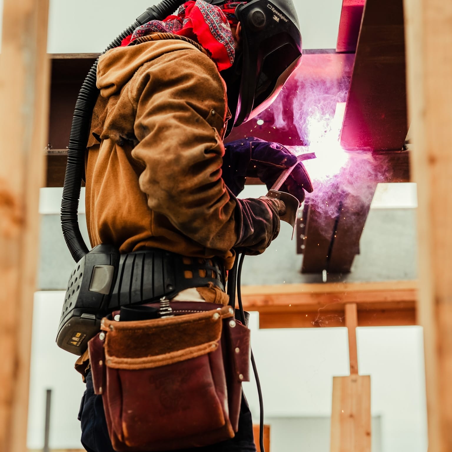 A welder is welding on a construction site for Floating Homes in Seattle, working as a Floating Homes Contractor.