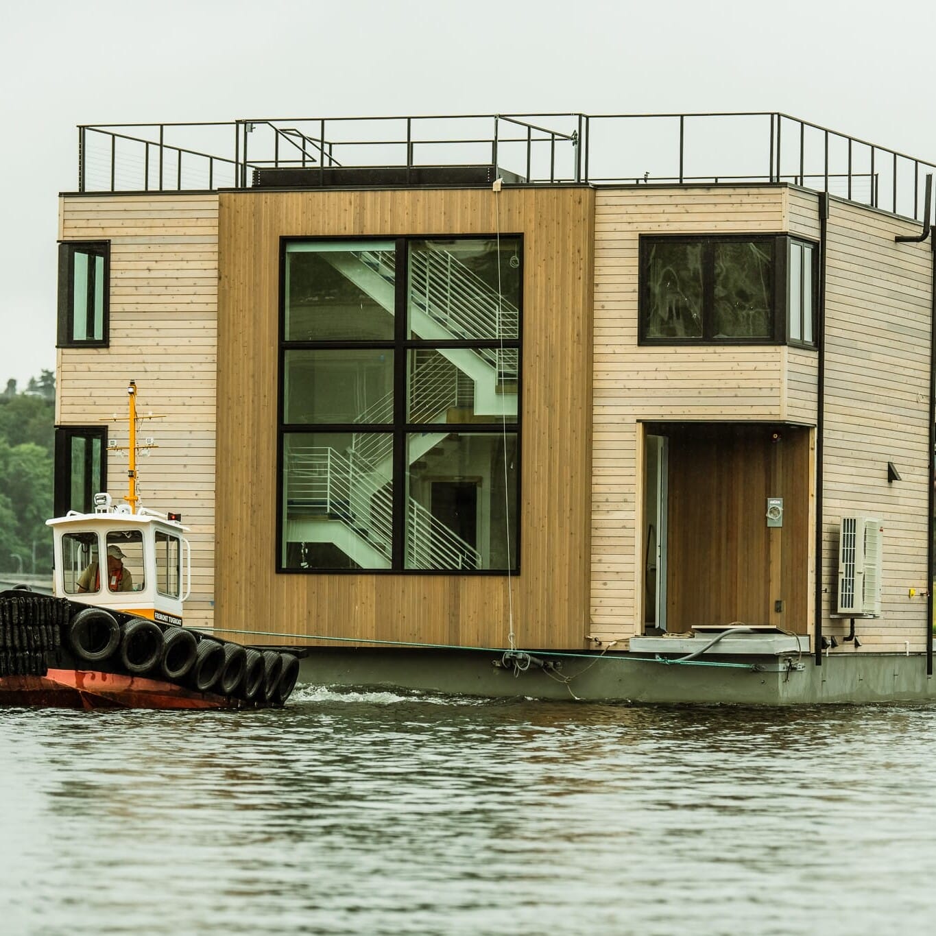 A Seattle Floating Home, a boat with a house on it floating in the water.