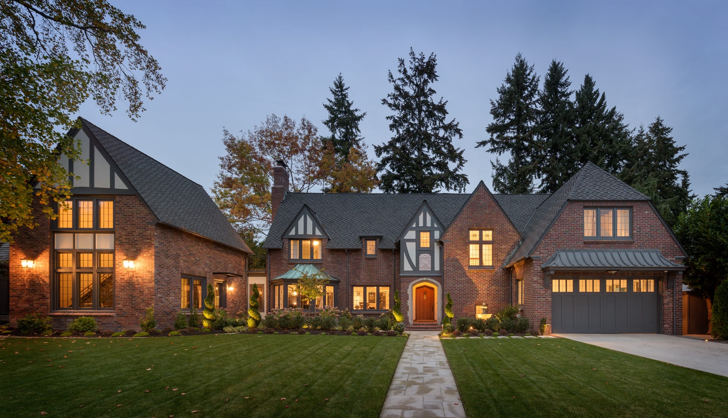 The exterior of a brick home at dusk.