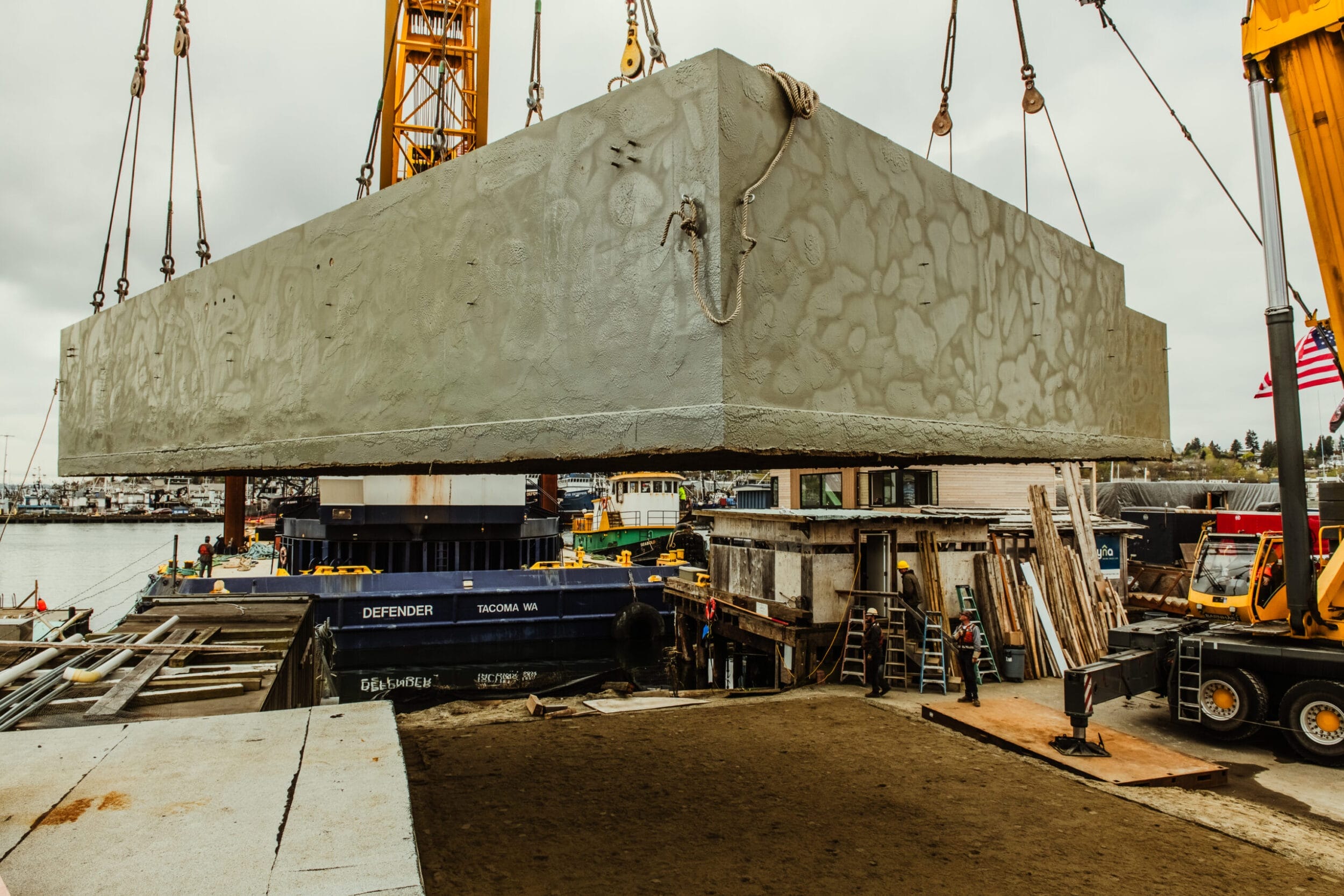 Floating home lifted by crane.